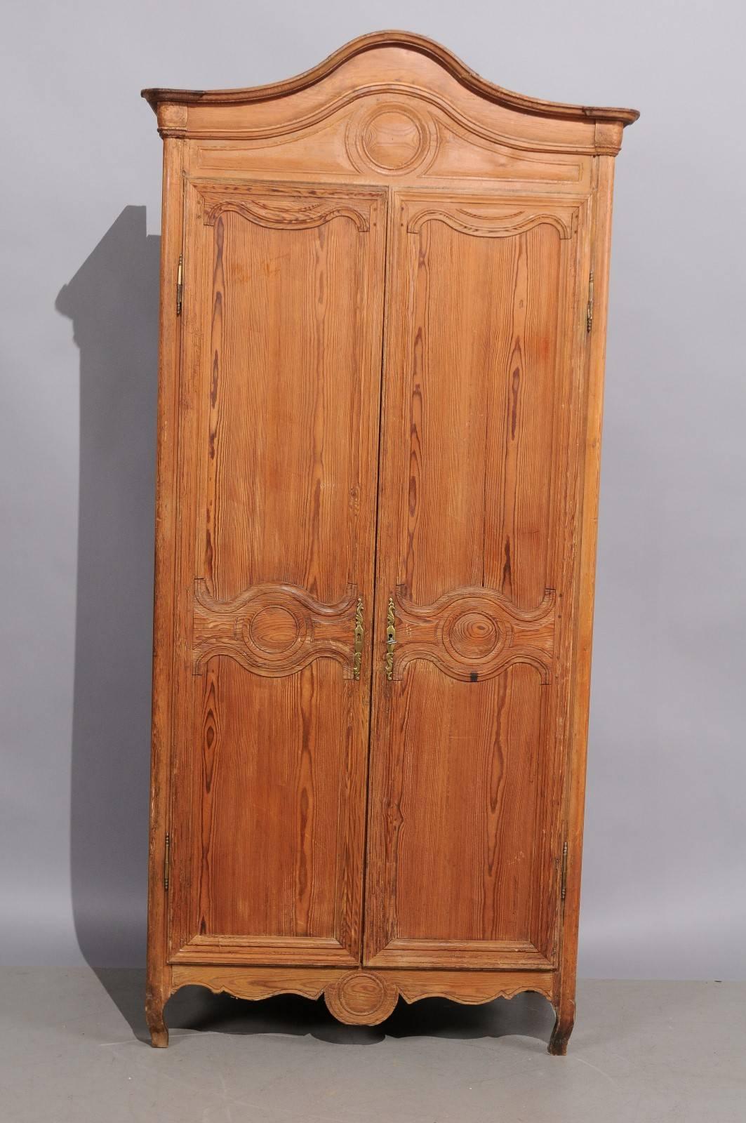 Louis XV style armoire in pine with double cabinet door, arched cornice, cabriole feet, and one (1) interior shelf, 19th century, France.