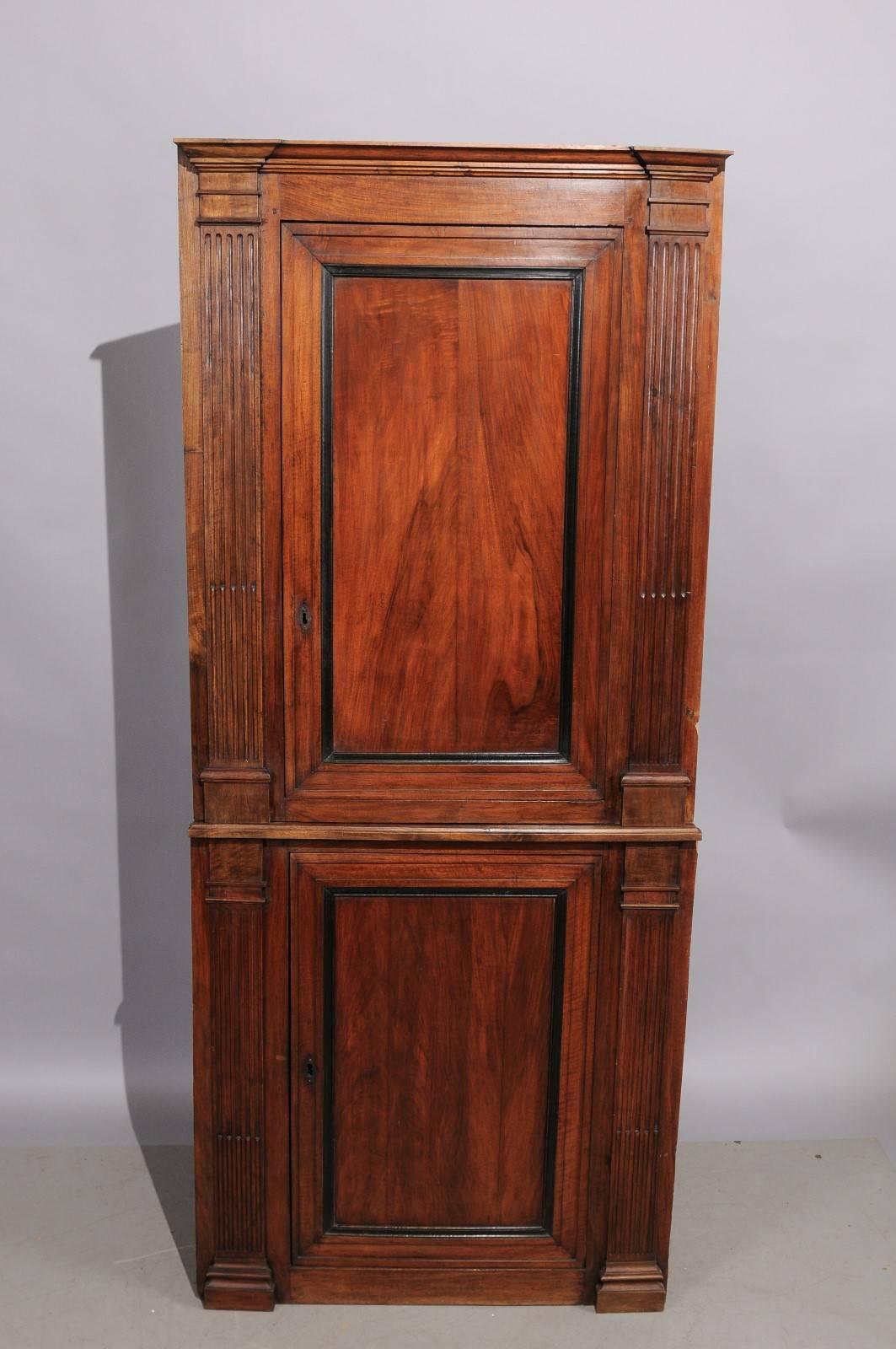 A late 18th century French walnut corner cupboard with 2 doors, fluted column detail and ebonized moulding. 

 