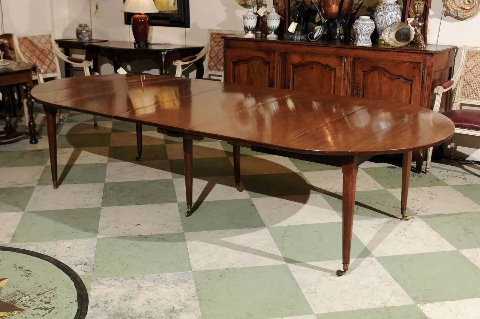 Late 18th century dining in mahogany with three leaves, tapered legs and brass castors. The three leaves were made at later date.

William Word Fine Antiques, Atlanta's source for antique interiors since 1956. 

 