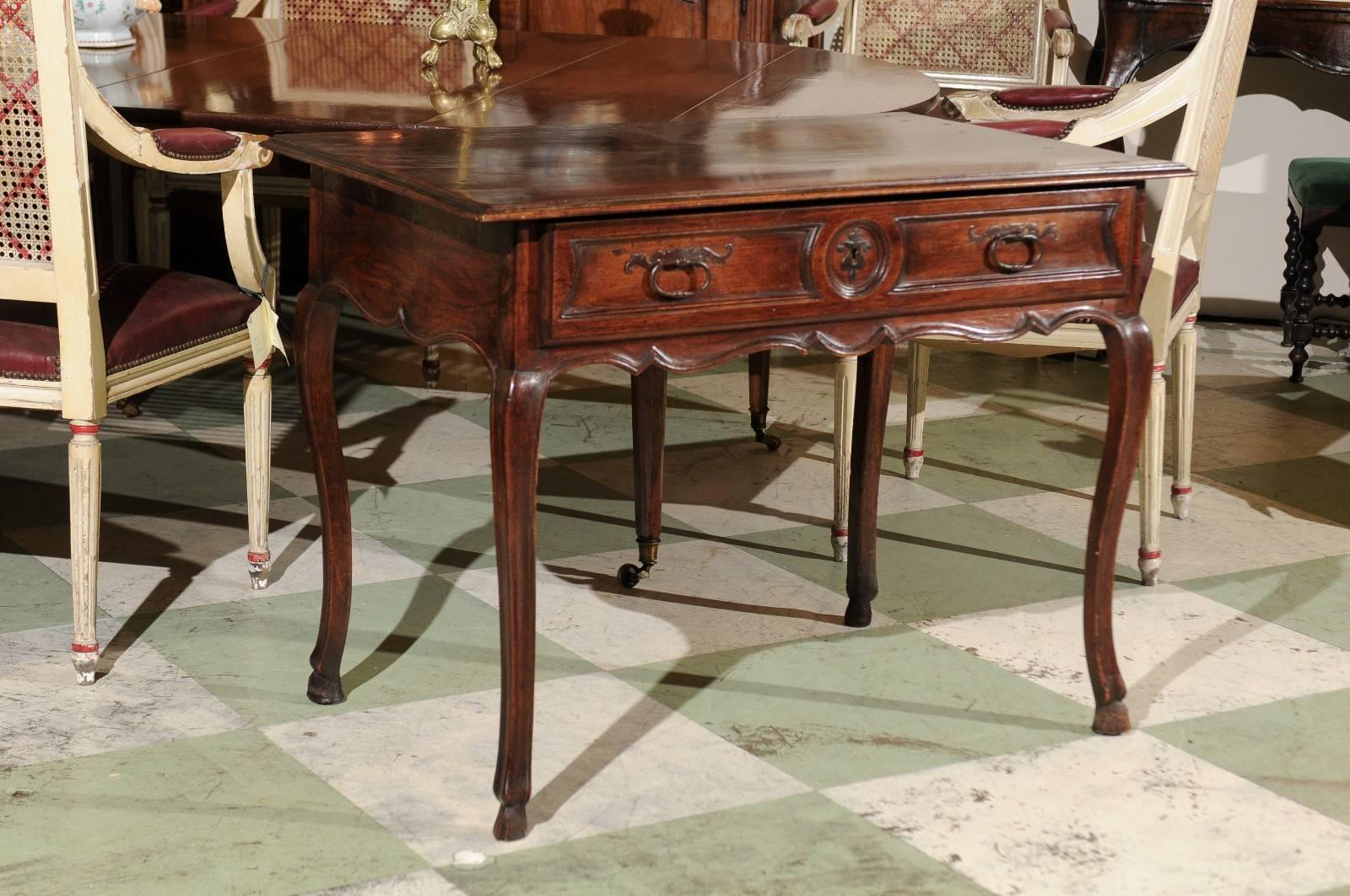 18th century French Louis XV side table in walnut with hoof feet and drawer, circa 1760.
