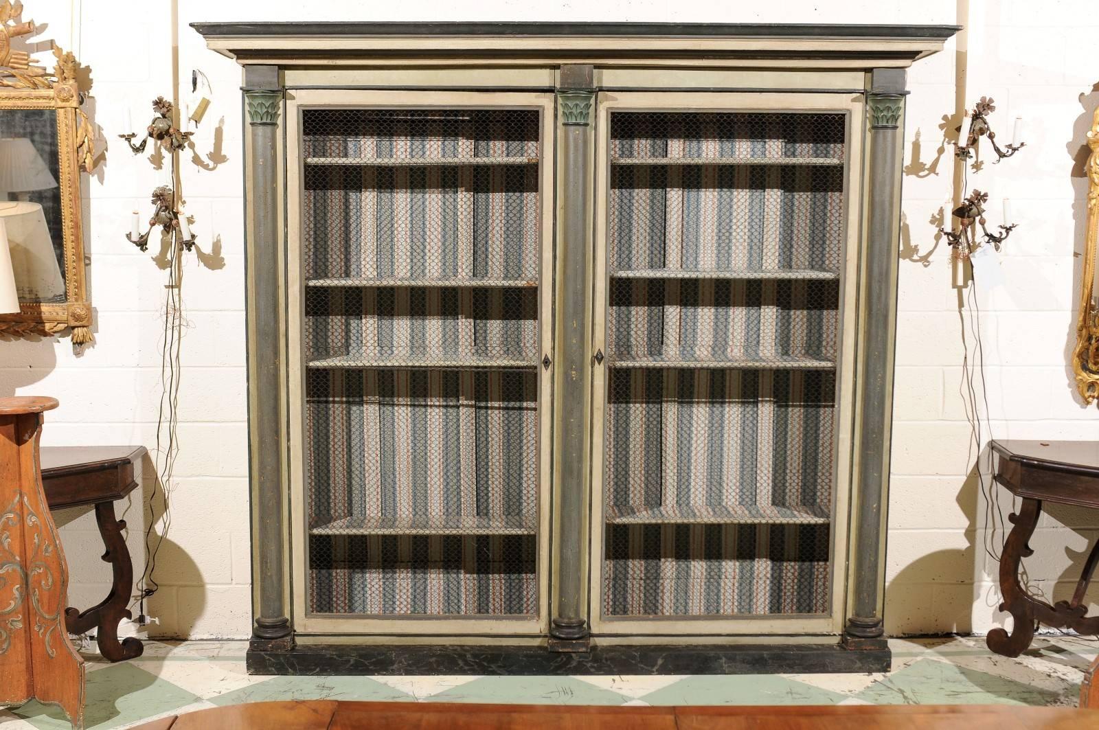 French painted green bookcase with columns in the neoclassical style.