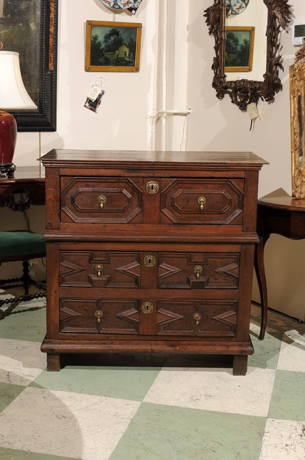 Jacobean style English oak cottage chest with three-drawer, geometric carving and brass tear drop pulls.

William Word Antiques: Atlanta's source for antique interiors since 1956.