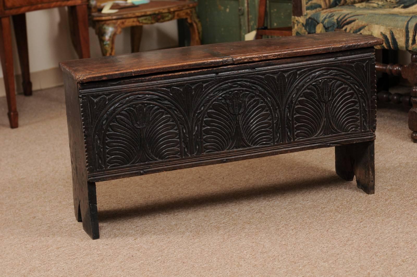 Petite Footed Oak Coffer with Hinged Lid and Carved Front Panel featuring Tulip Motif, 18th Century England. 