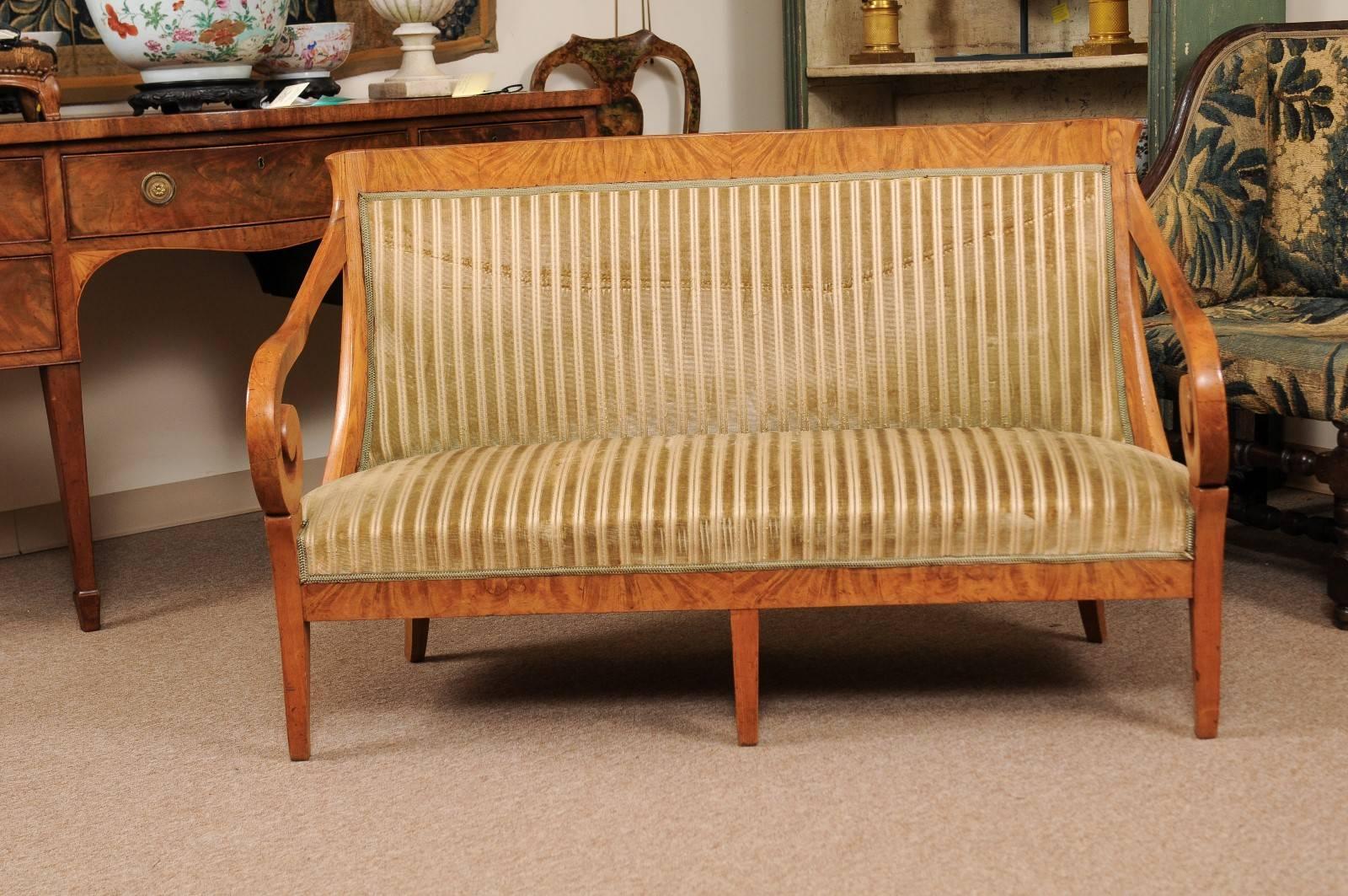 The Biedermeier settee with modern velvet upholstery, curved back, scrolled arms terminating in tapered splayed legs. 

  