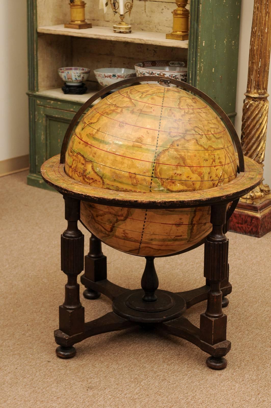 Large papier mâché globe mounted on brown painted wood stand with fluted and turned columns and cross stretcher, Continental Europe, late 19th century.