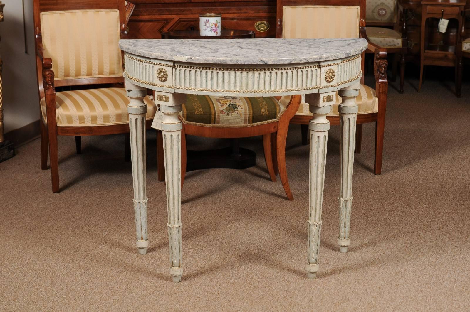 Louis XVI style demilune console table in painted finish featuring fluted detail and faux marbleized top, 19th century, France.