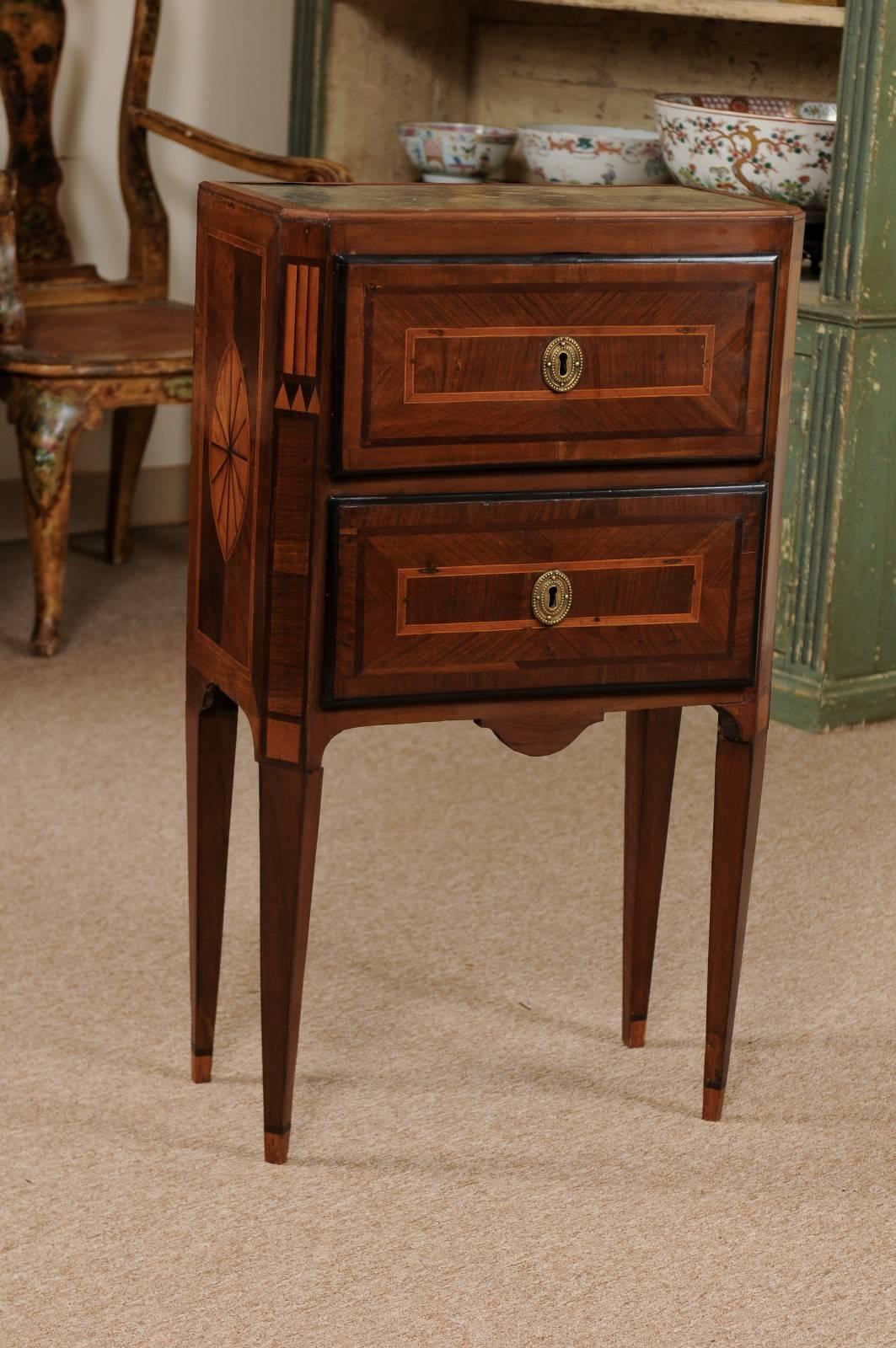 Neoclassical style Italian two drawer commodini with inset grey marble top, inlay, crossbanding, two drawers and tapered legs. The wood composed of walnut, satinwood, boxwood and ebonized wood.

William Word Fine Antiques: Atlanta's source for