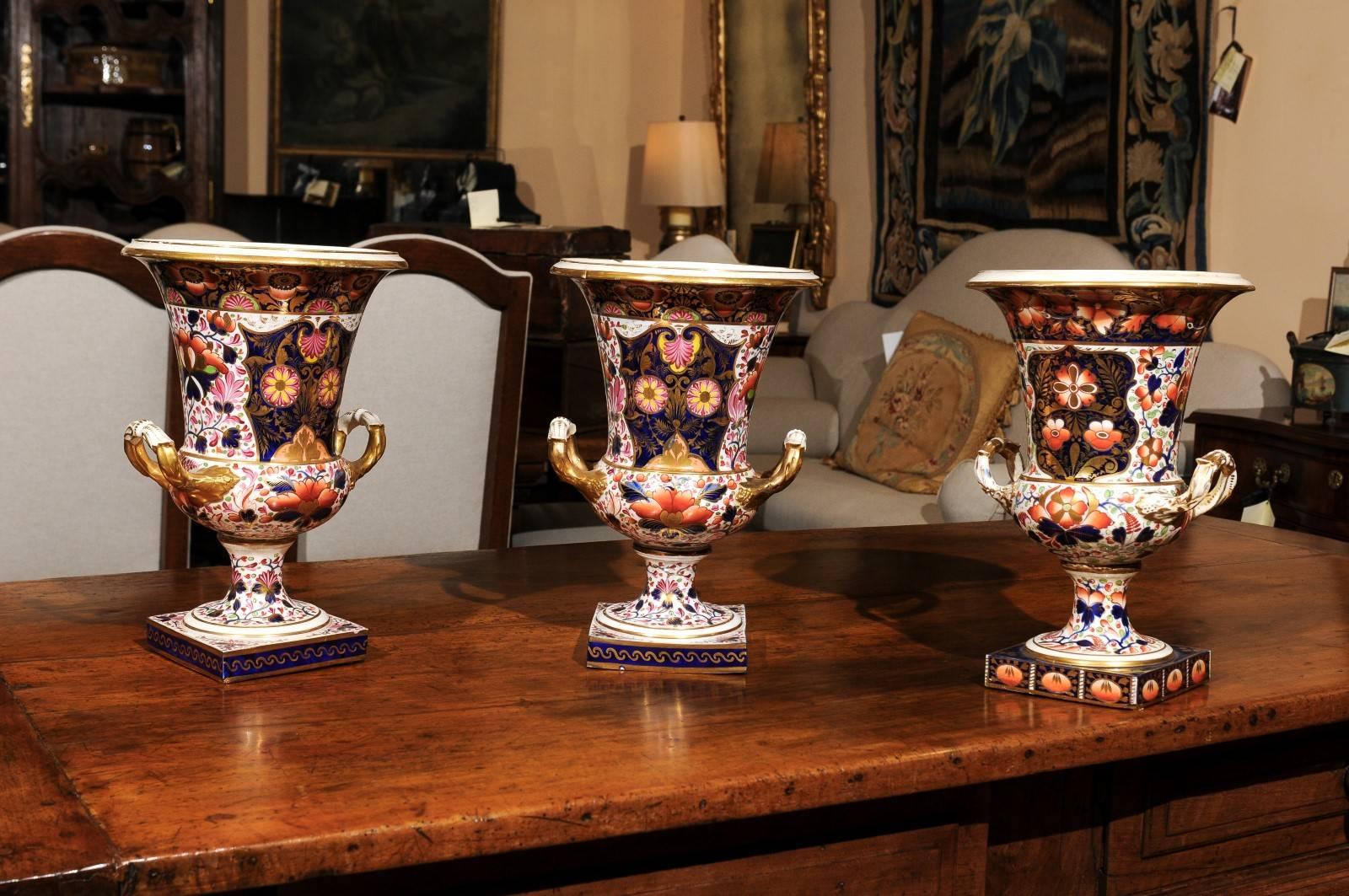 Set of 3 large Derby Urns, England 19th century.