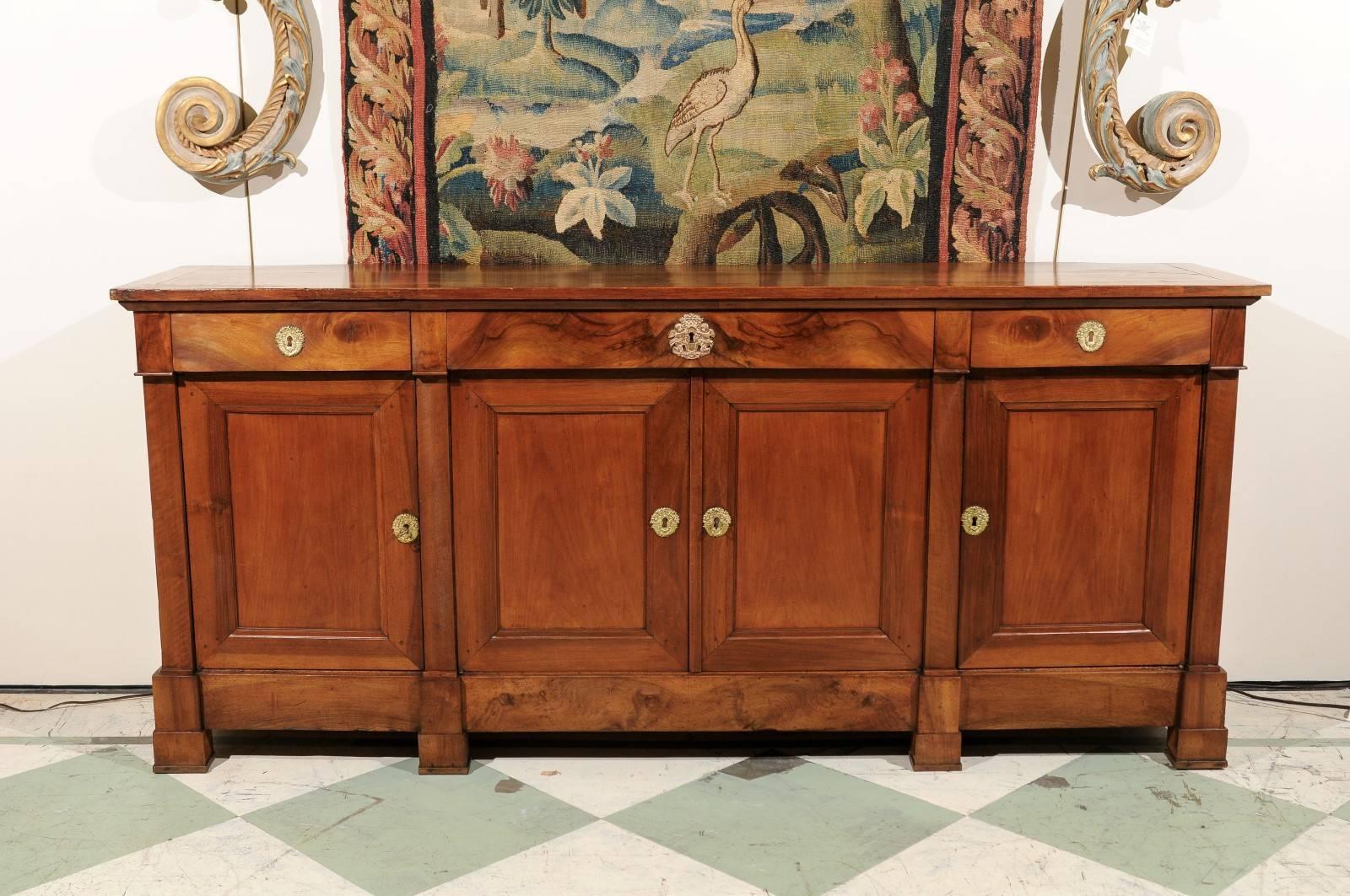 Early 19th century, French Empire Enfilade in walnut and fruitwood with three drawers and four cabinets below.