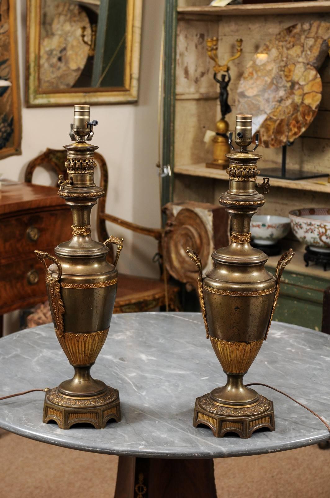 A pair of French Neoclassical style French gilt metal urns wired into lamps. Recently wired for U.S.A electricity. 



 