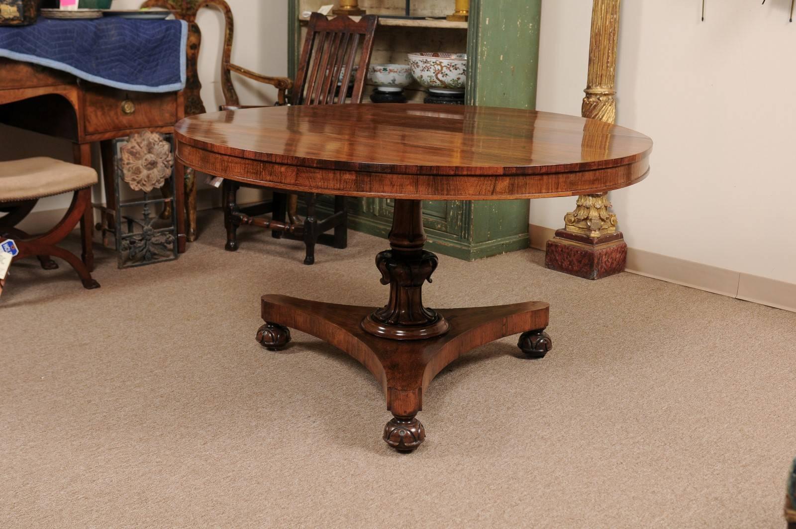 William IV style centre table in rosewood with carved stem, tripod base and carved bun feet. The table with tilting mechanism.

William Word Fine Antiques: Atlanta's source for antique interiors since 1956.