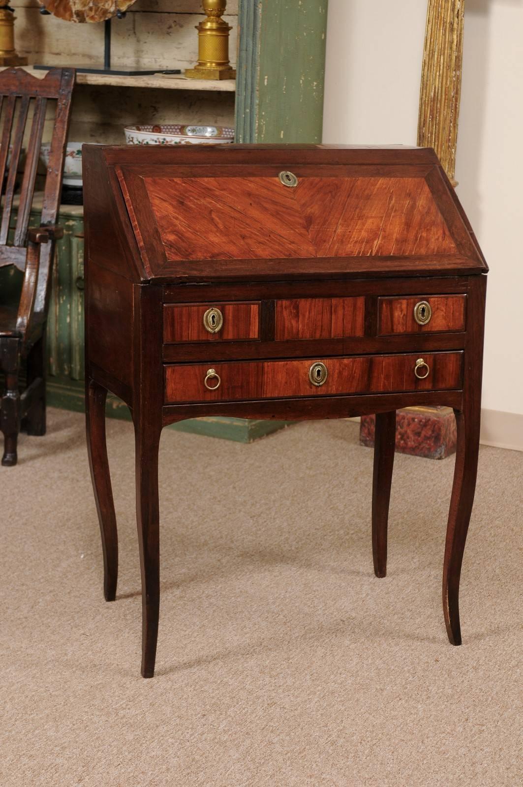 Petite slant-front bureau in kingwood with fitted interior & leather blotter.