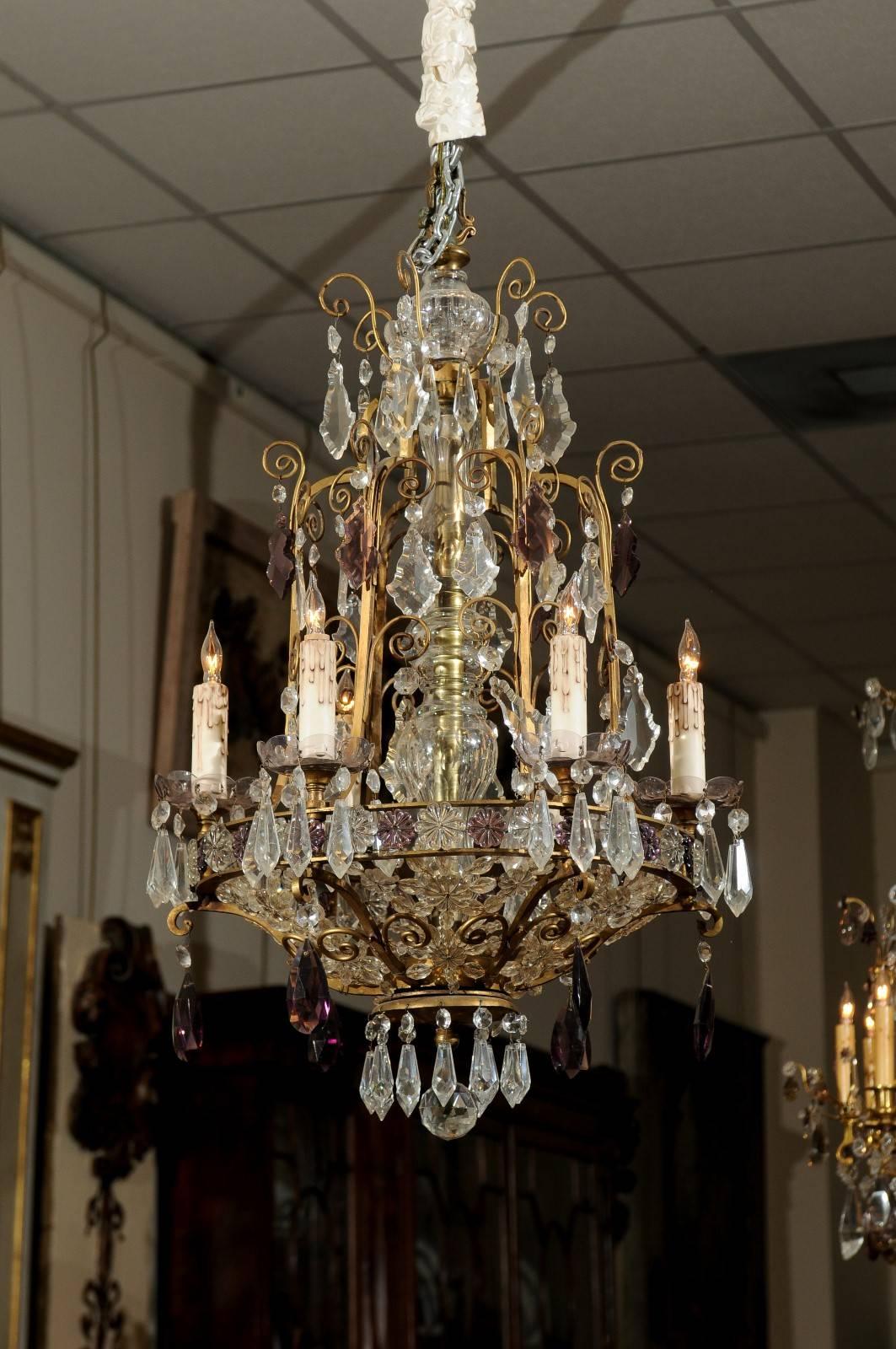 Late 19th / early 20th century chandelier with bronze frame featuring scroll detail and clear and amethyst colored prisms.