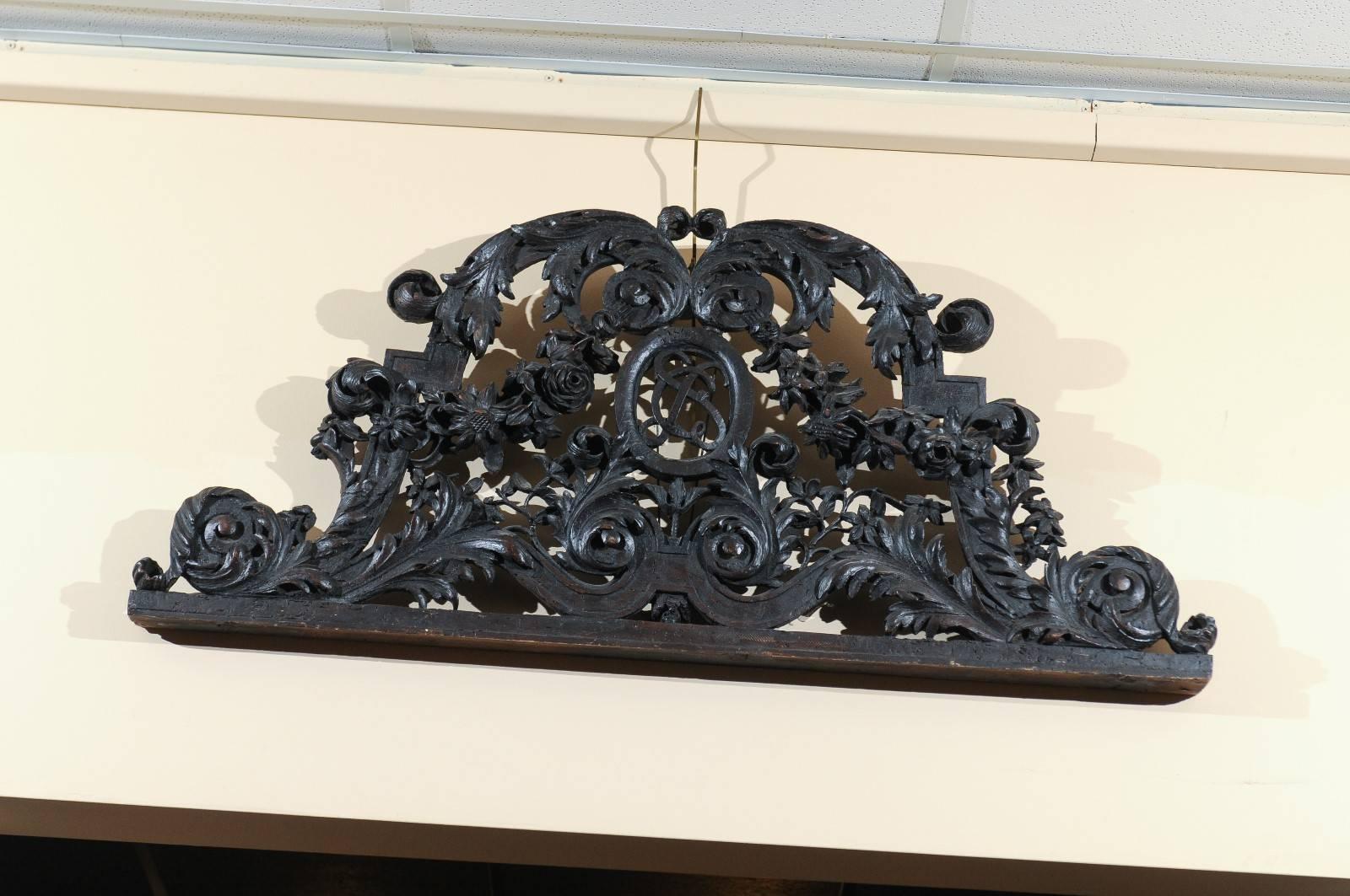 Carved oak overdoor / architectural element featuring floral garland motifs, France, circa 1780.