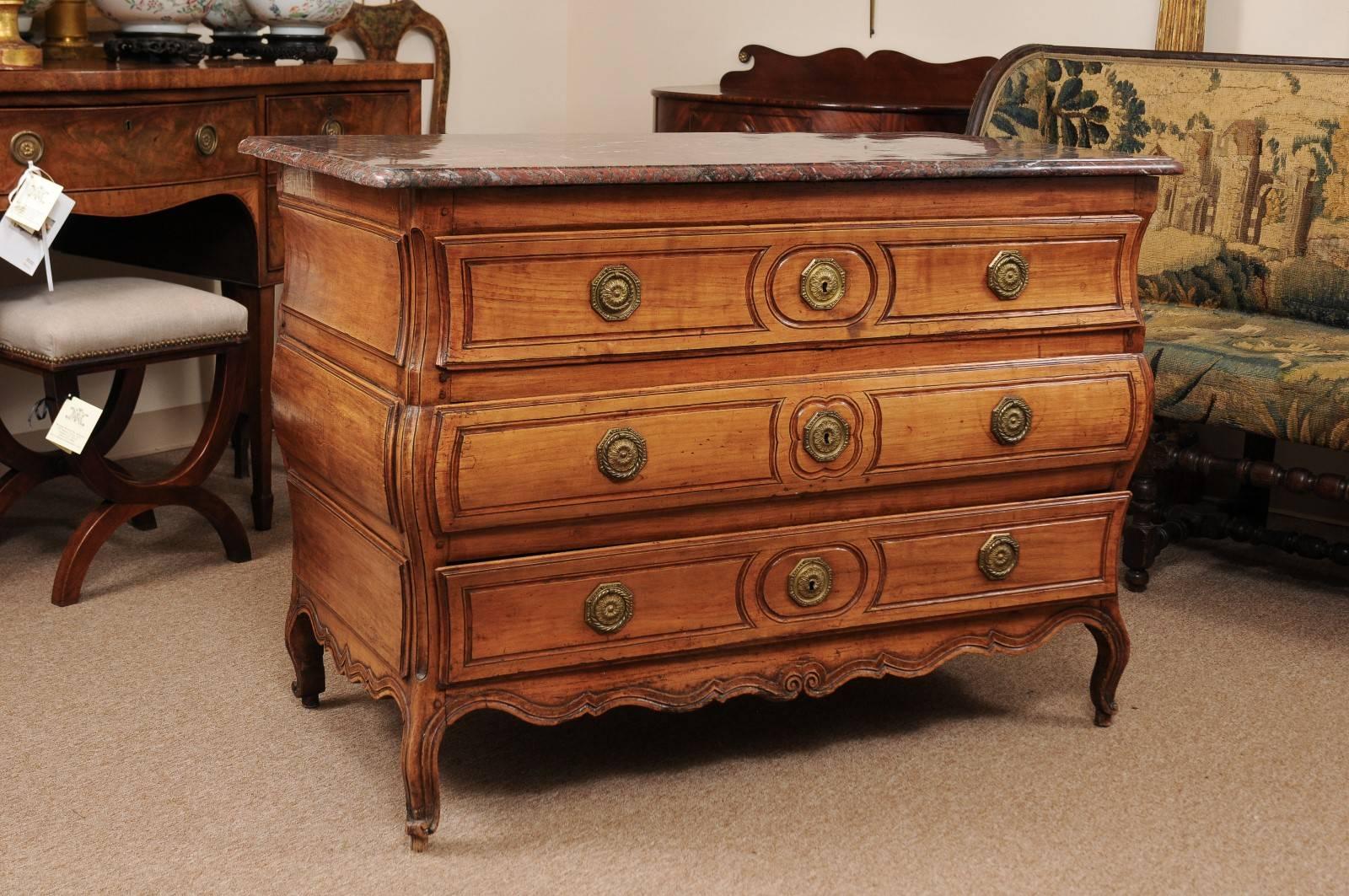 Louis XV bombe form commode in fruitwood with three (3) drawers, cabriole feet, and red marble top, France, circa 1750.