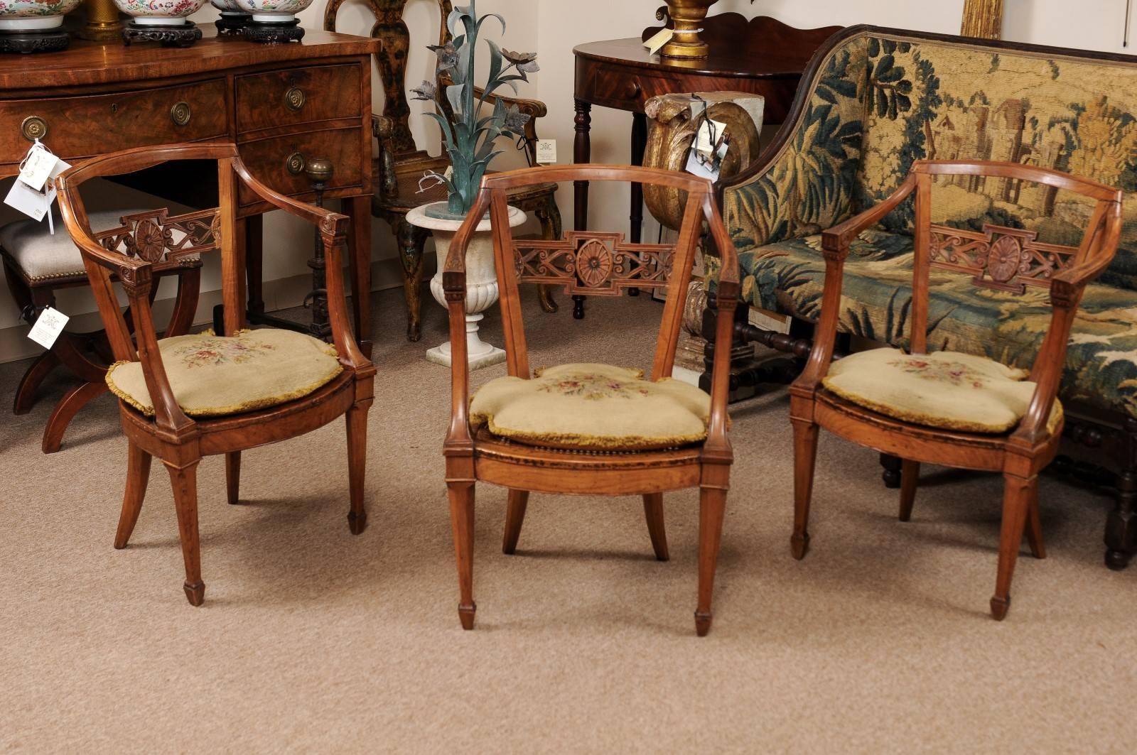 Neoclassical period fruitwood open arm chair with cane seat and tapered legs ending in spade feet, 18th century, Italy. Needlepoint loose cushion available.