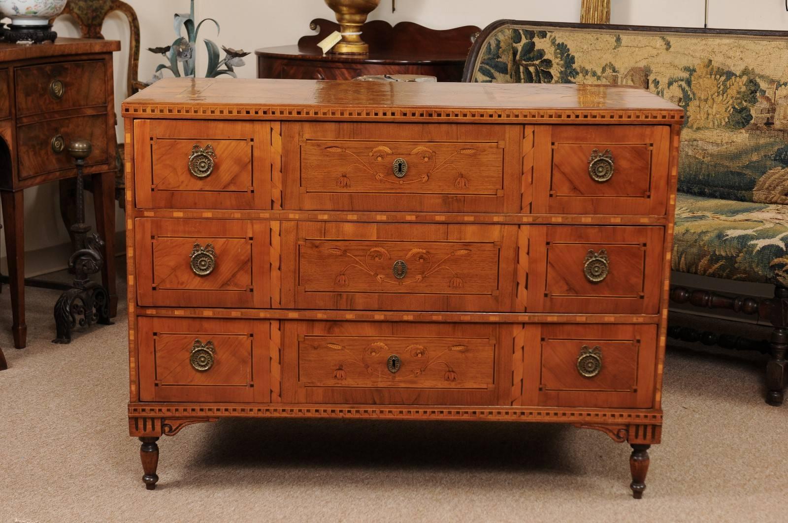 Late 18th century South German neoclassical walnut and fruitwood commode with parquetry inlay and marquetry inlay of foliage. All resting on turned legs.

 