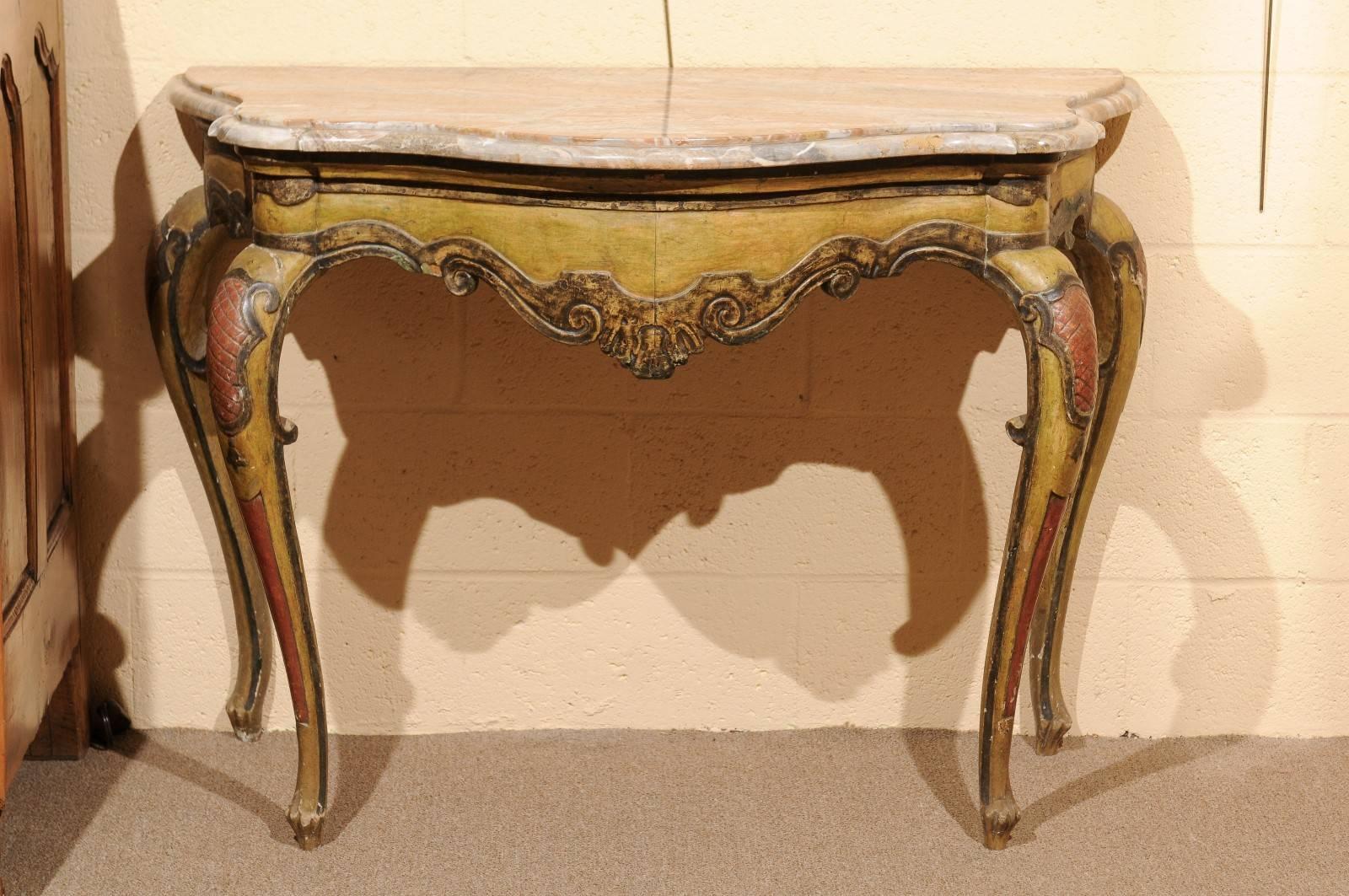 Pair of Italian Rococo style painted consoles with shaped striated marble tops. The marble tops are in grey, yellow and rust hues. The painted consoles are in yellow and rust hues.

 