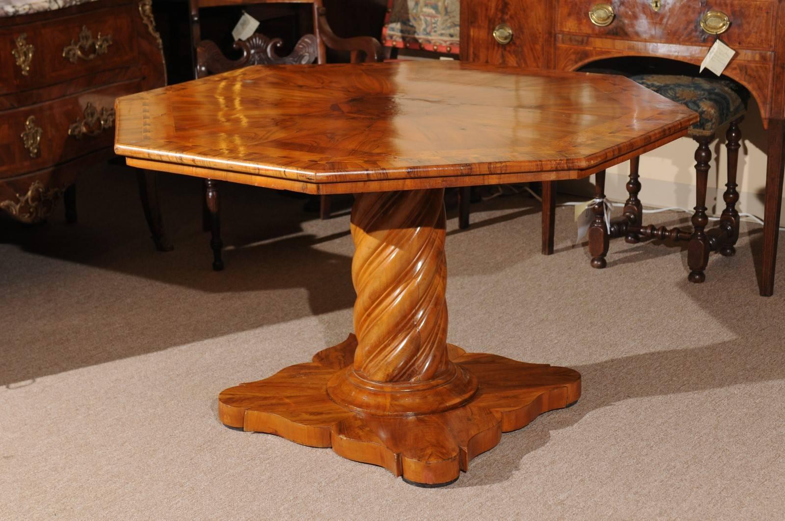 Octagonal shaped neoclassical style inlaid walnut center table with barley twist pedestal base, Italy 19th century.