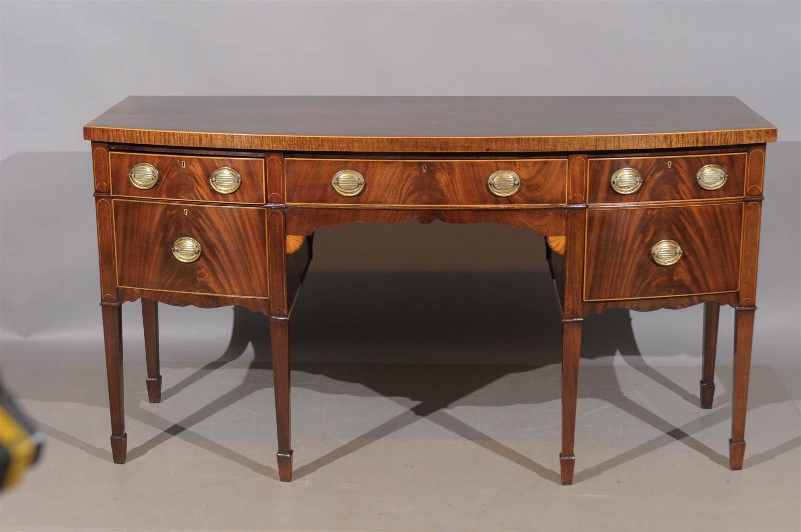19th century English bowfront sideboard in mahogany with crossbanding, inlay and cellarette drawer.