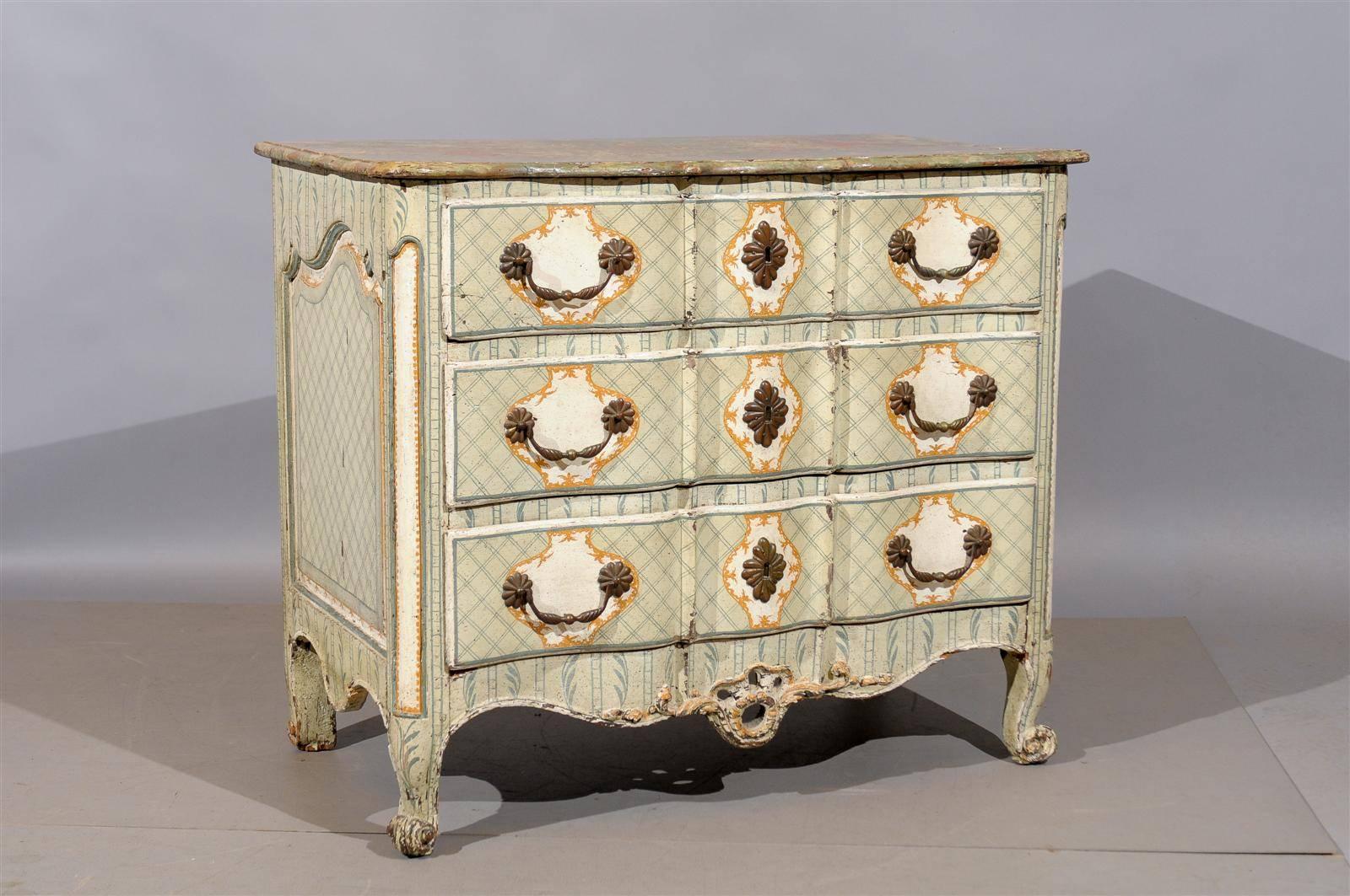 An 18th century French Louis XV painted commode with linen fold shaped front, paneled sides and three drawers.