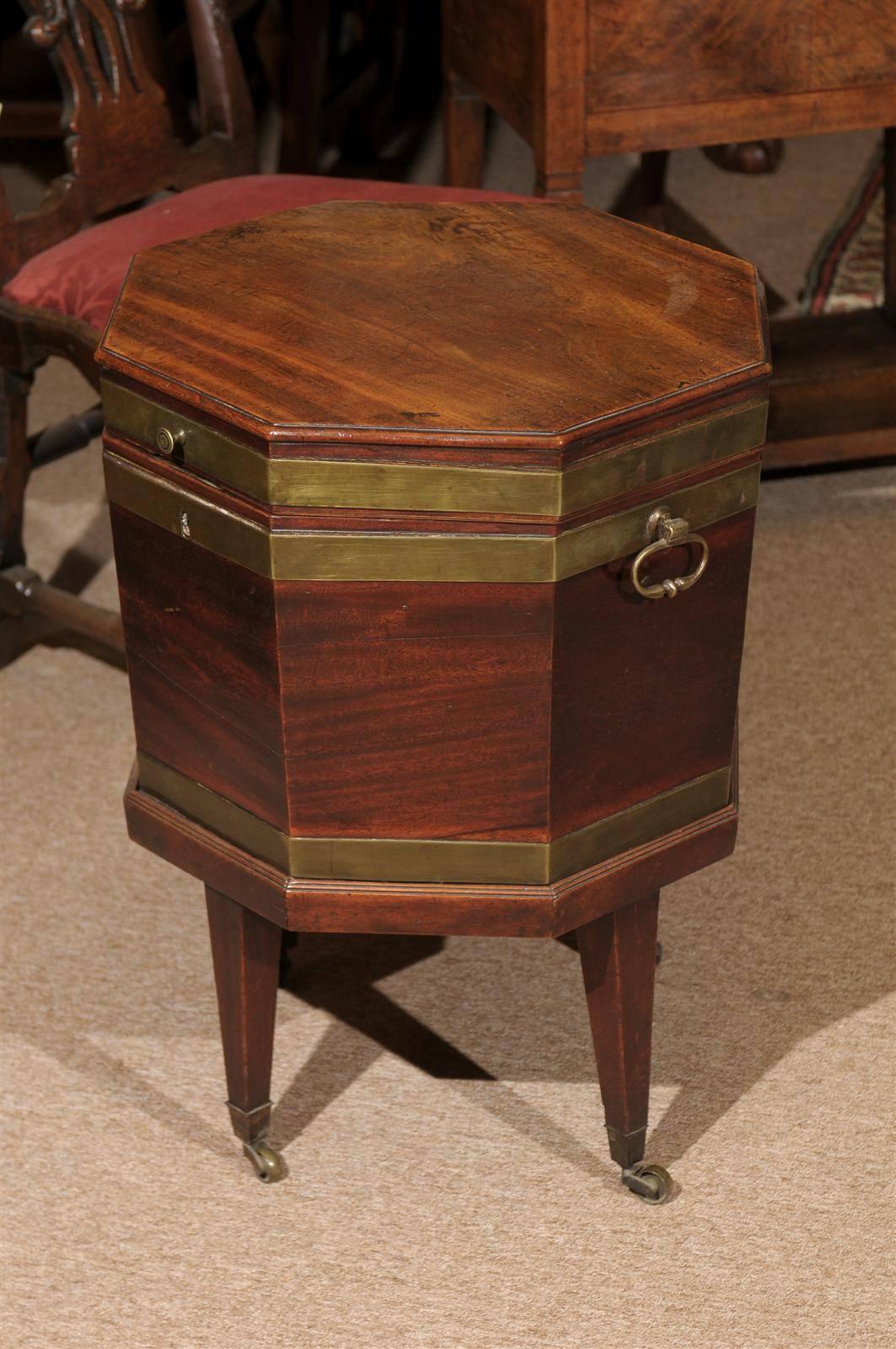 19th century English octagonal mahogany and brass cellarette on stand.