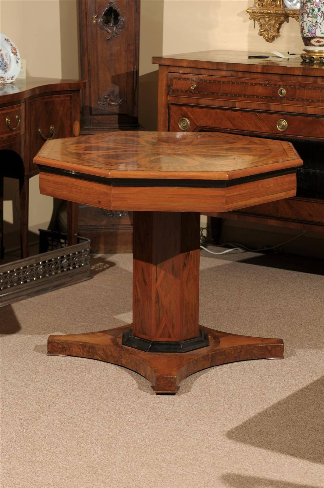 A 19th century Italian neoclassical style octagonal center table with parquetry inlay and pedestal base. 