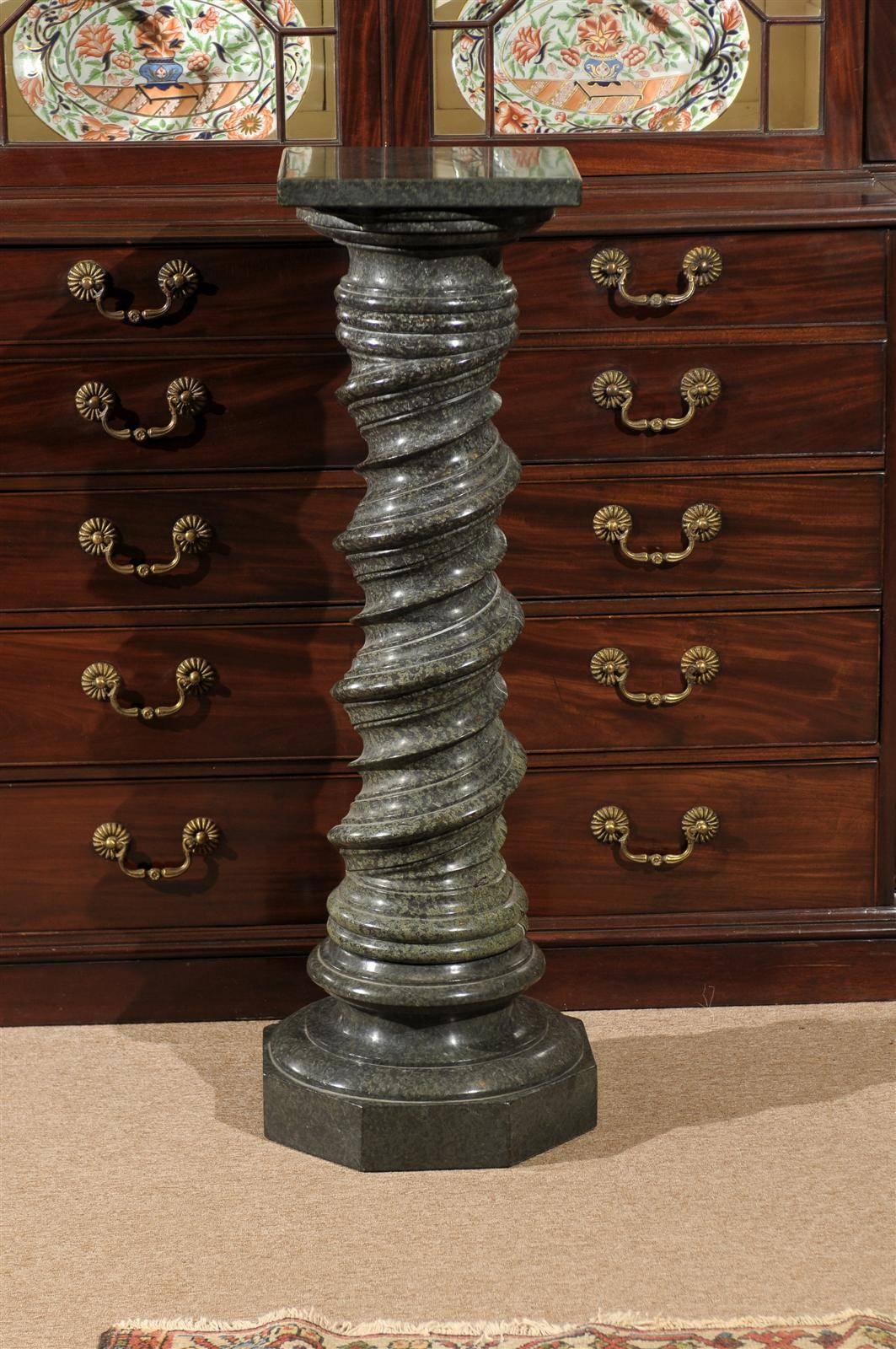 An Italian green marble pedestal with carved barley twist column. 
