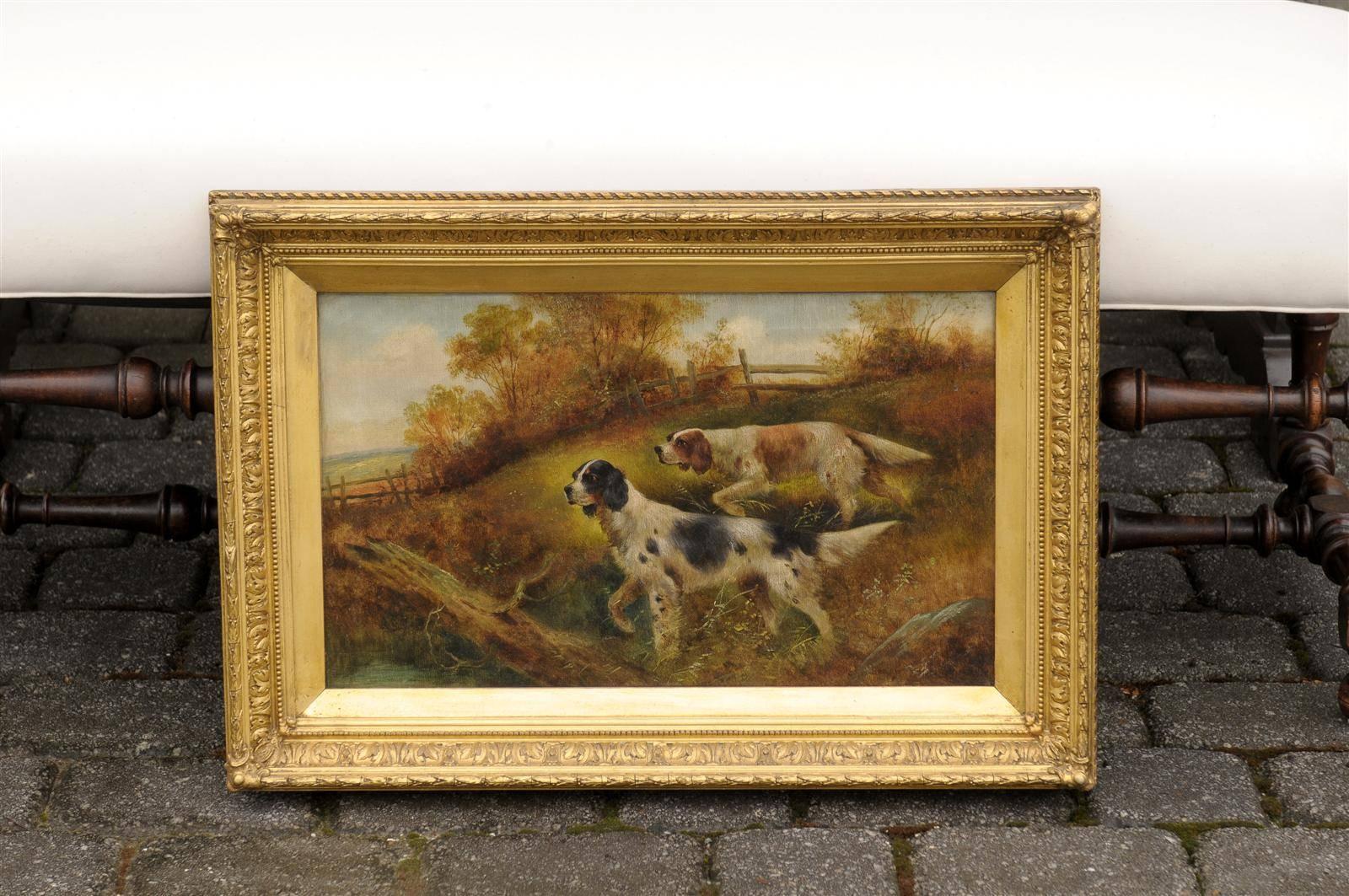 A Victorian era English oil painting featuring sporting dogs by painter Charles Dudley.  This spectacular painting features what appear to be two English Springer Spaniels in mid hunt, one black and white and the other brown and white.  Both dogs