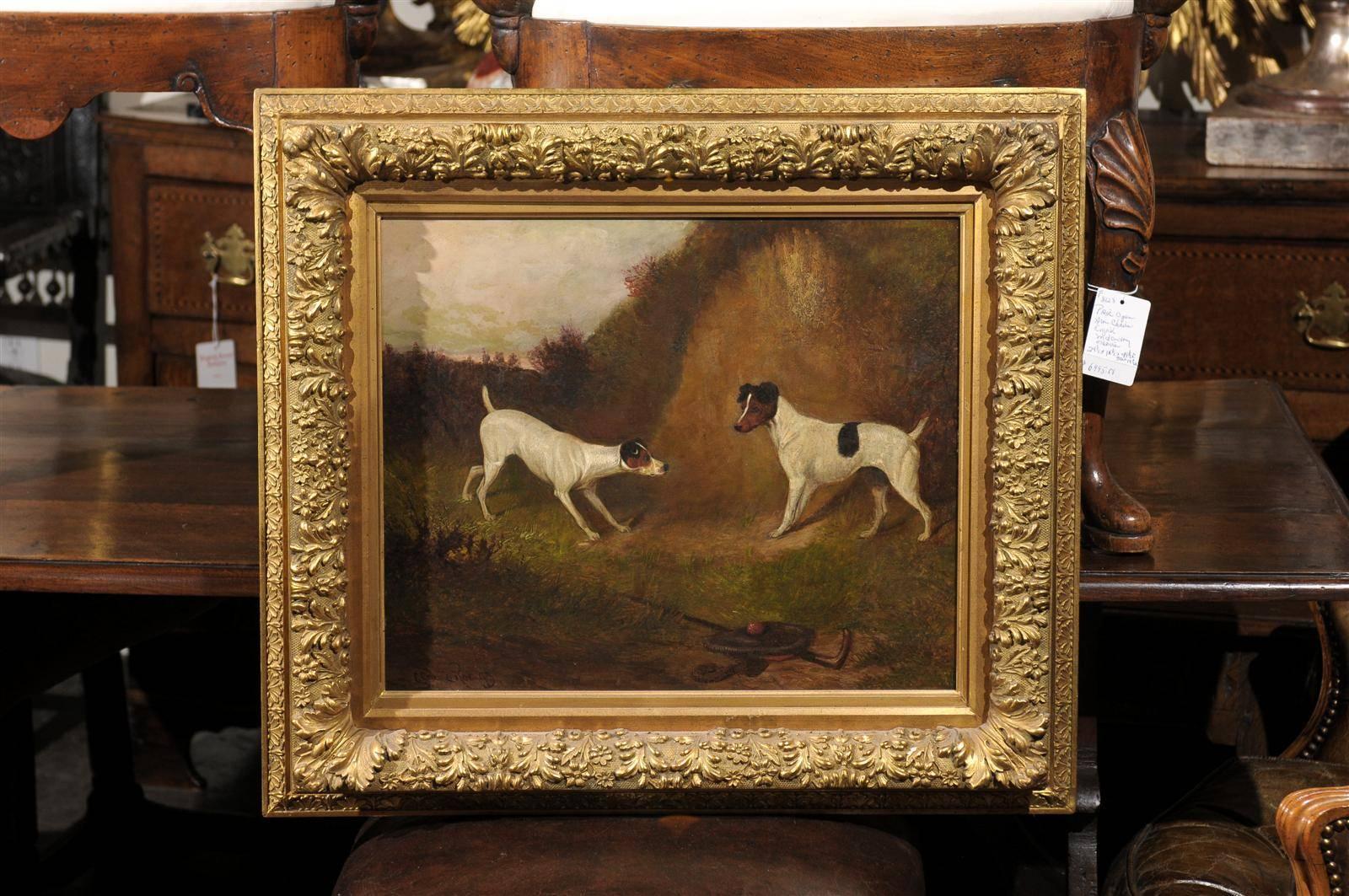 This English oil on canvas late 19th century painting of two terrier dogs was made by British artist Colin Graeme Roe (1858-1910) and is signed lower left. The scene is set in the country and the color tones are in the greens and browns. The center
