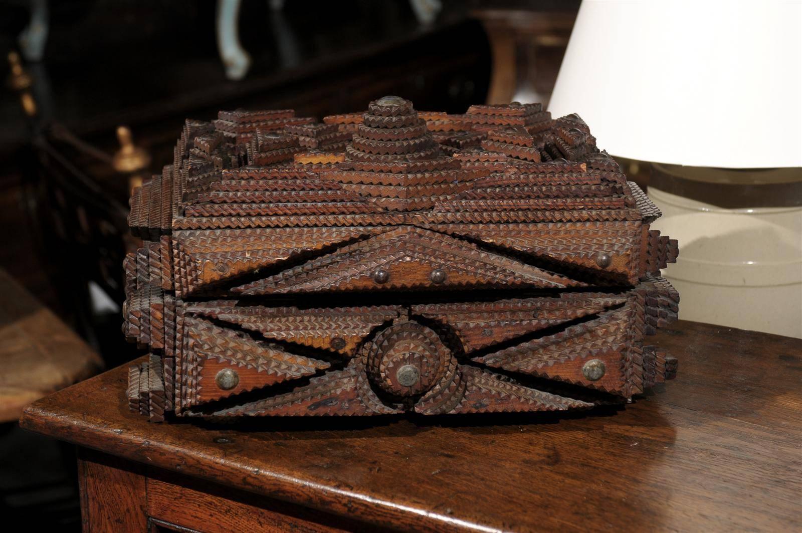 An American tramp art box from the early 20th century with key.  This wonderful American tramp art box is decorated with layers of geometrical motifs. Tramp Art was an art movement popular between the 1870s and the 1940s all around the world and