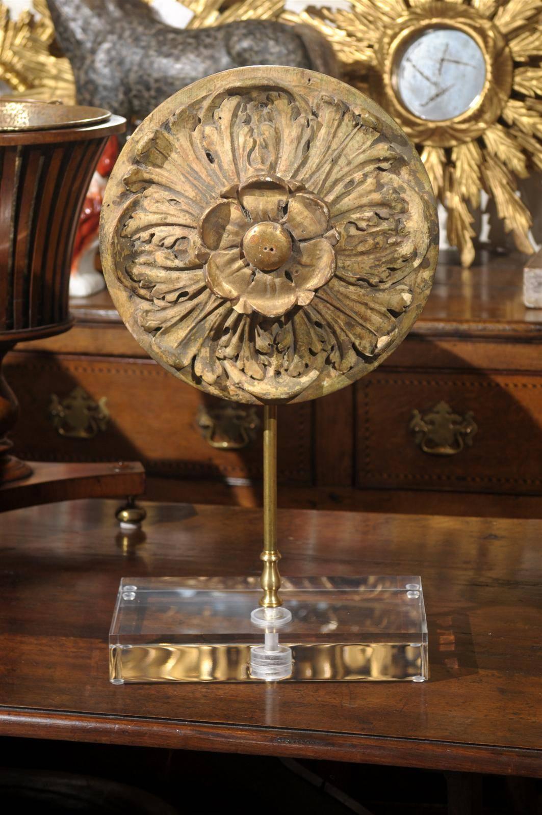 A French carved medallion mounted on a custom Lucite base. This carved medallion from the turn of the 19th-20th century was originally part of an elegant ceiling panel. Freed from its original panel, this French medallion is securely mounted to its