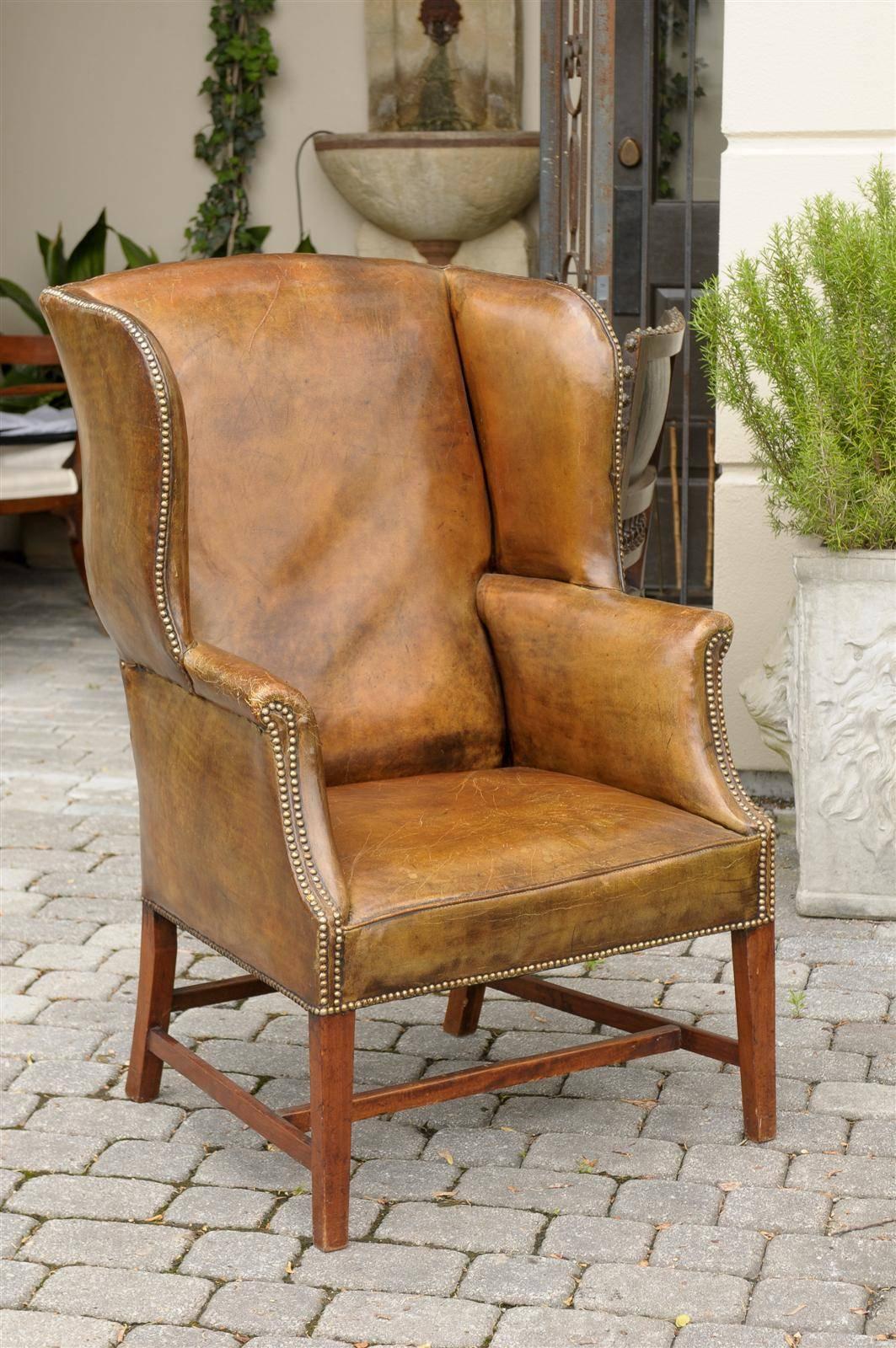 19 th c.English leather wing chair with brass tacks and beautiful profile.
