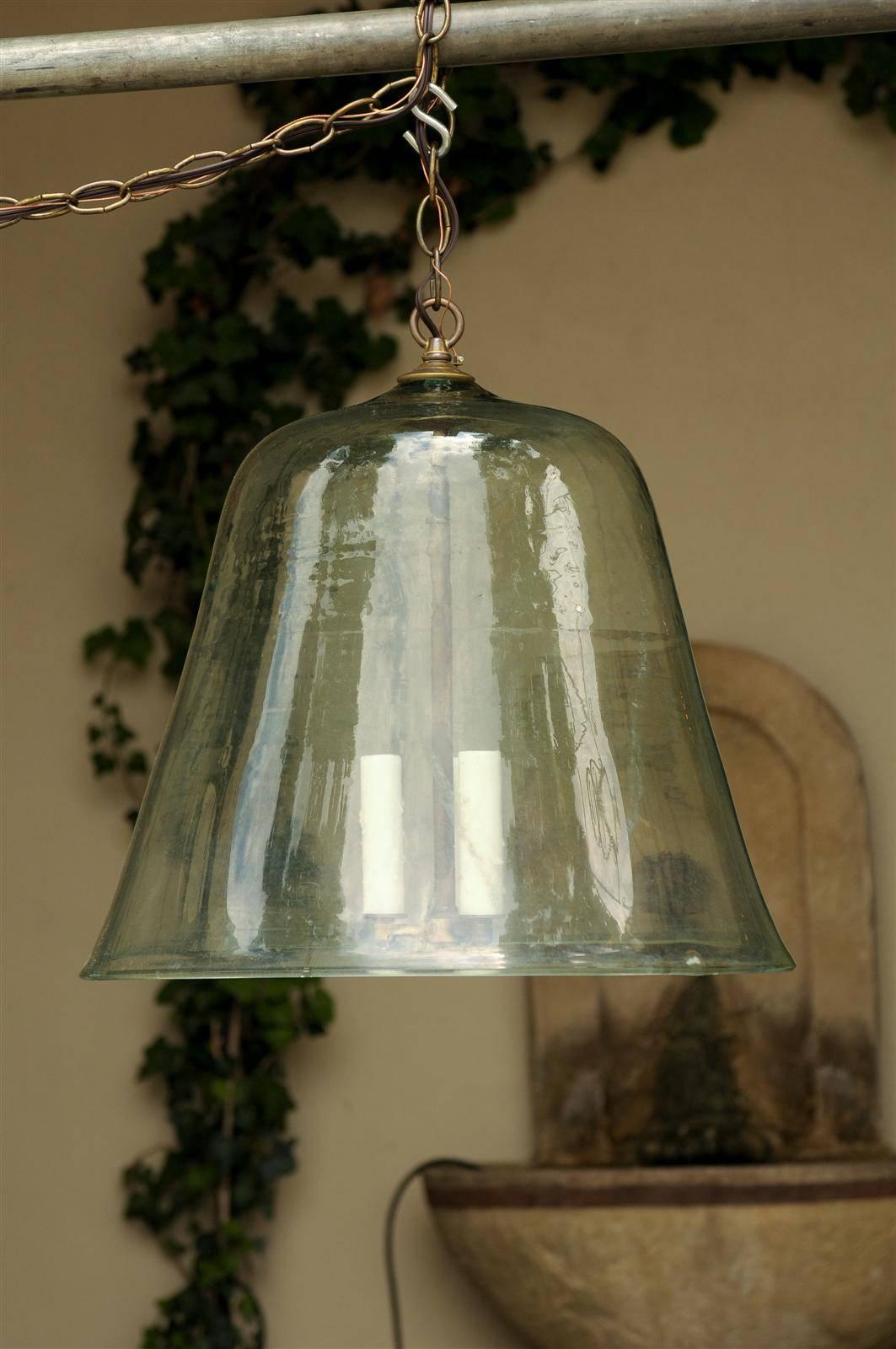 This French bell jar light fixture from the late 19th, early 20th century was made from an old French glass cloche (bell in French). The hand-blown cloche has been newly wired for the US with three sockets supporting authentic wax sleeves. The