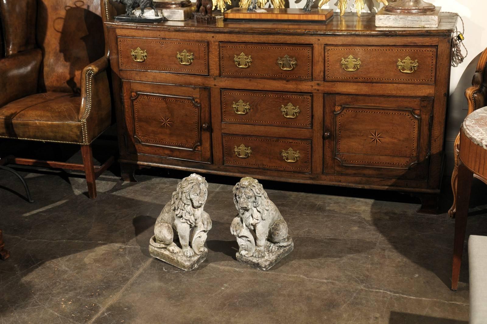 Mid-Century Modern Pair of French Mid-20th Century Seated Stone Lions with Shields and Fleur-de-Lys