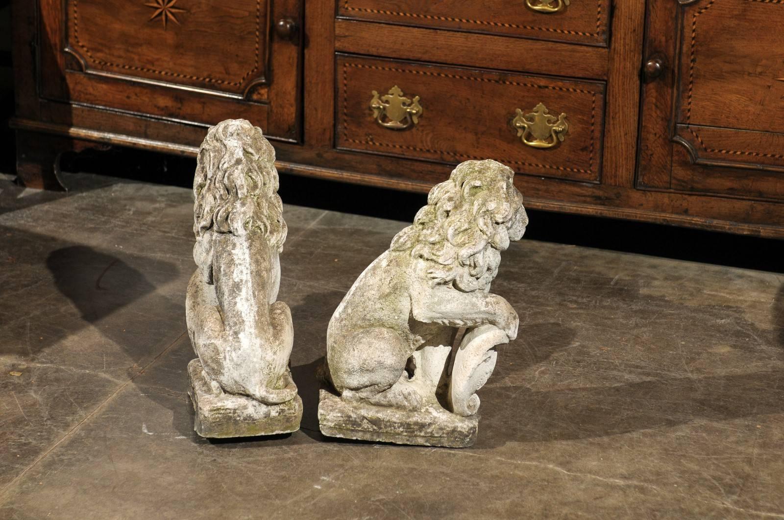 Composition Pair of French Mid-20th Century Seated Stone Lions with Shields and Fleur-de-Lys