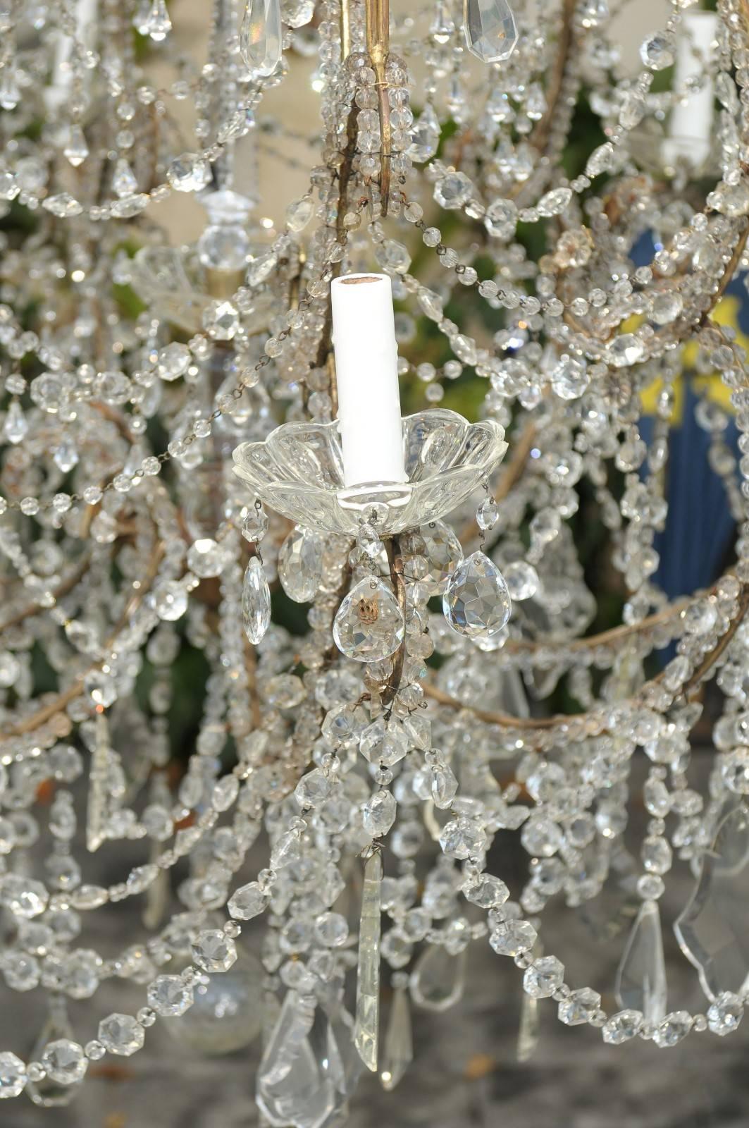 Large Italian 1920s Crystal Gilt Metal Eight-Light Chandelier with Scrolled Arms For Sale 4