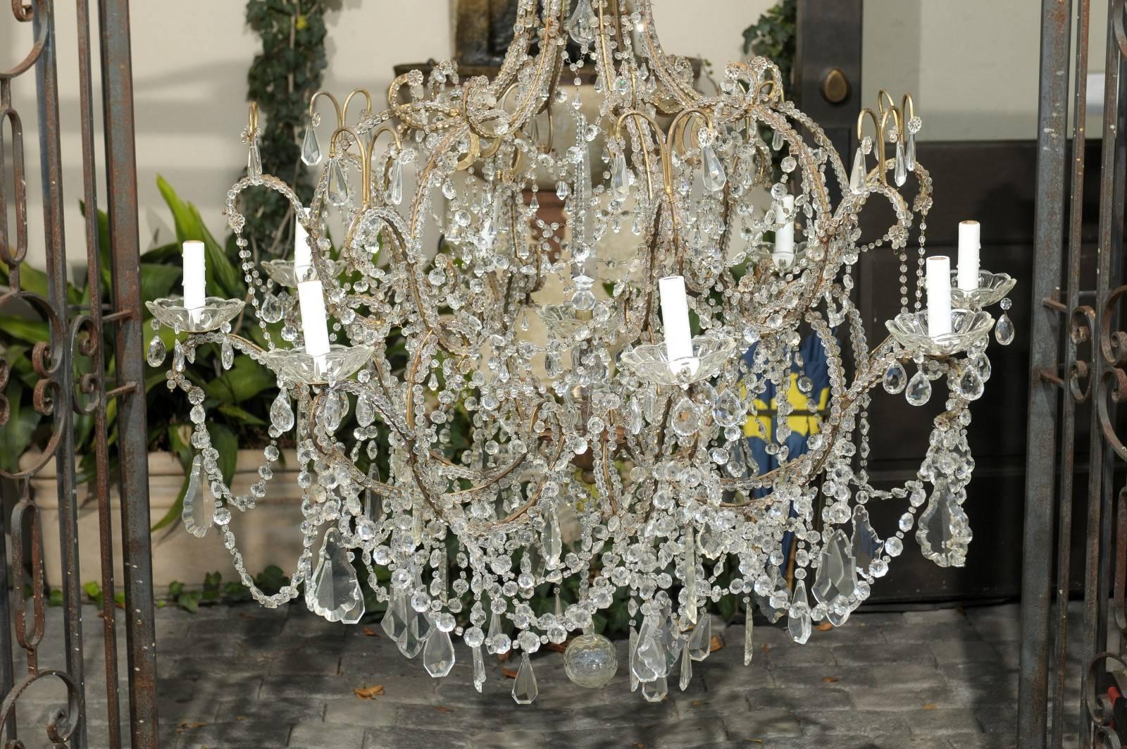 Large Italian 1920s Crystal Gilt Metal Eight-Light Chandelier with Scrolled Arms In Good Condition For Sale In Atlanta, GA