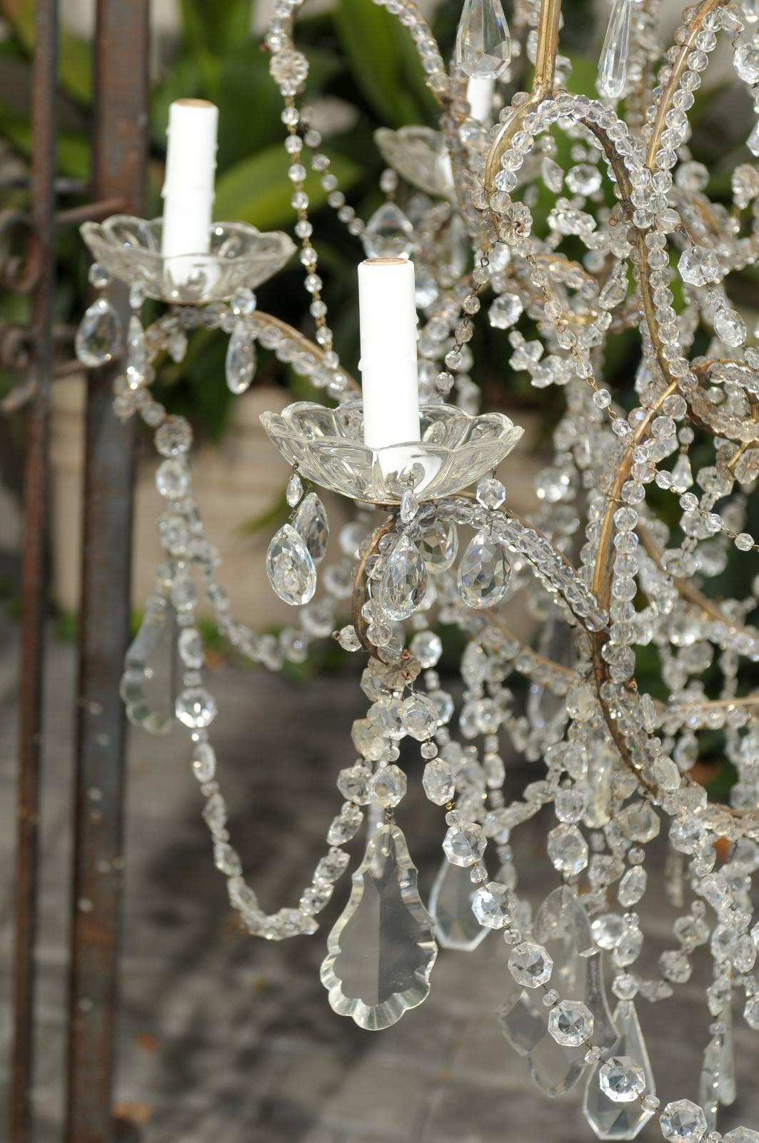 Large Italian 1920s Crystal Gilt Metal Eight-Light Chandelier with Scrolled Arms For Sale 3