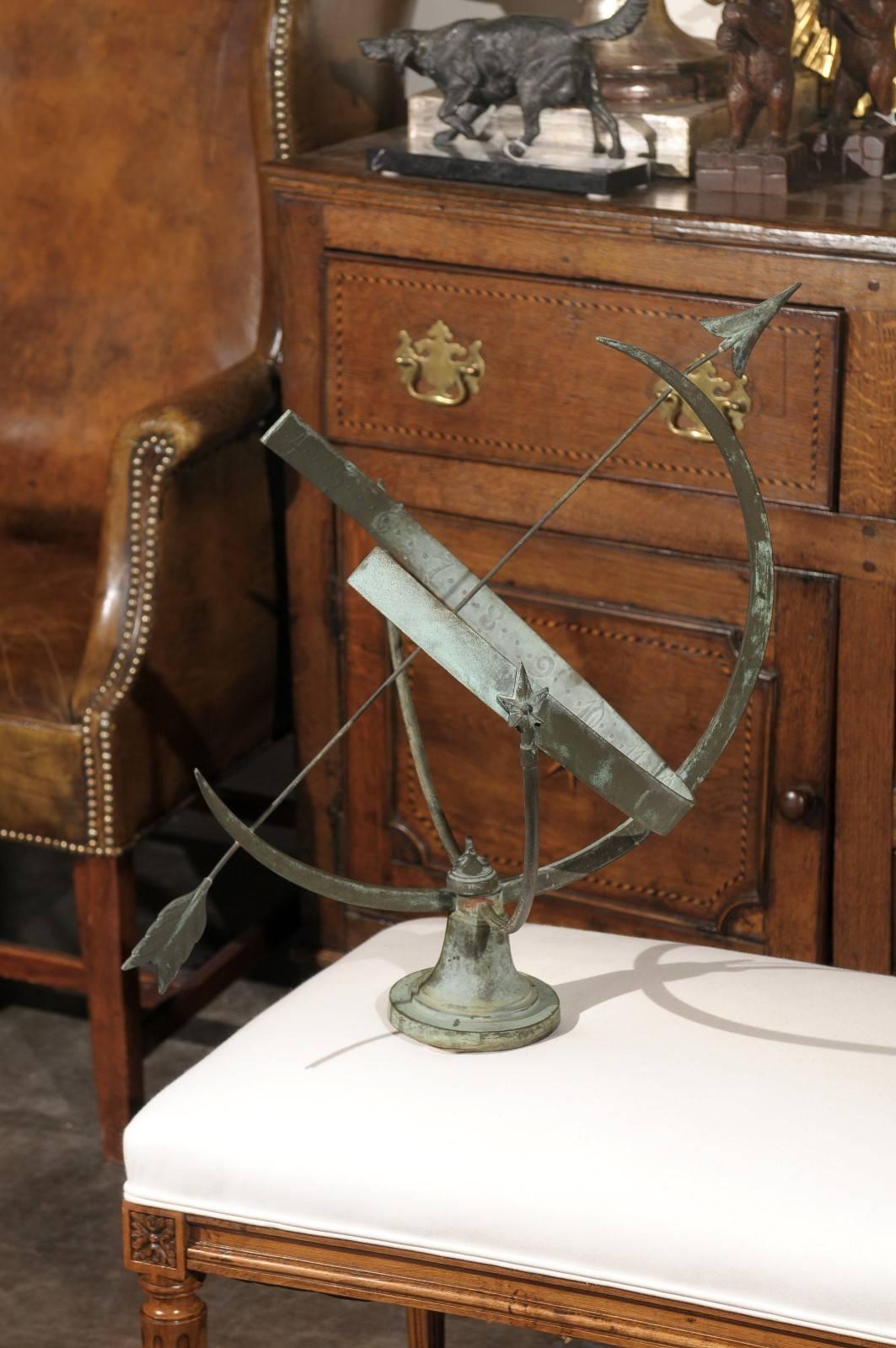 A metal armillary sphere sundial from the early 20th century. This circa 1920 armillary sphere sundial (also called shadow-clocks or equatorial sundials) features partial exterior rings that support the ecliptic ring upon which the hours are