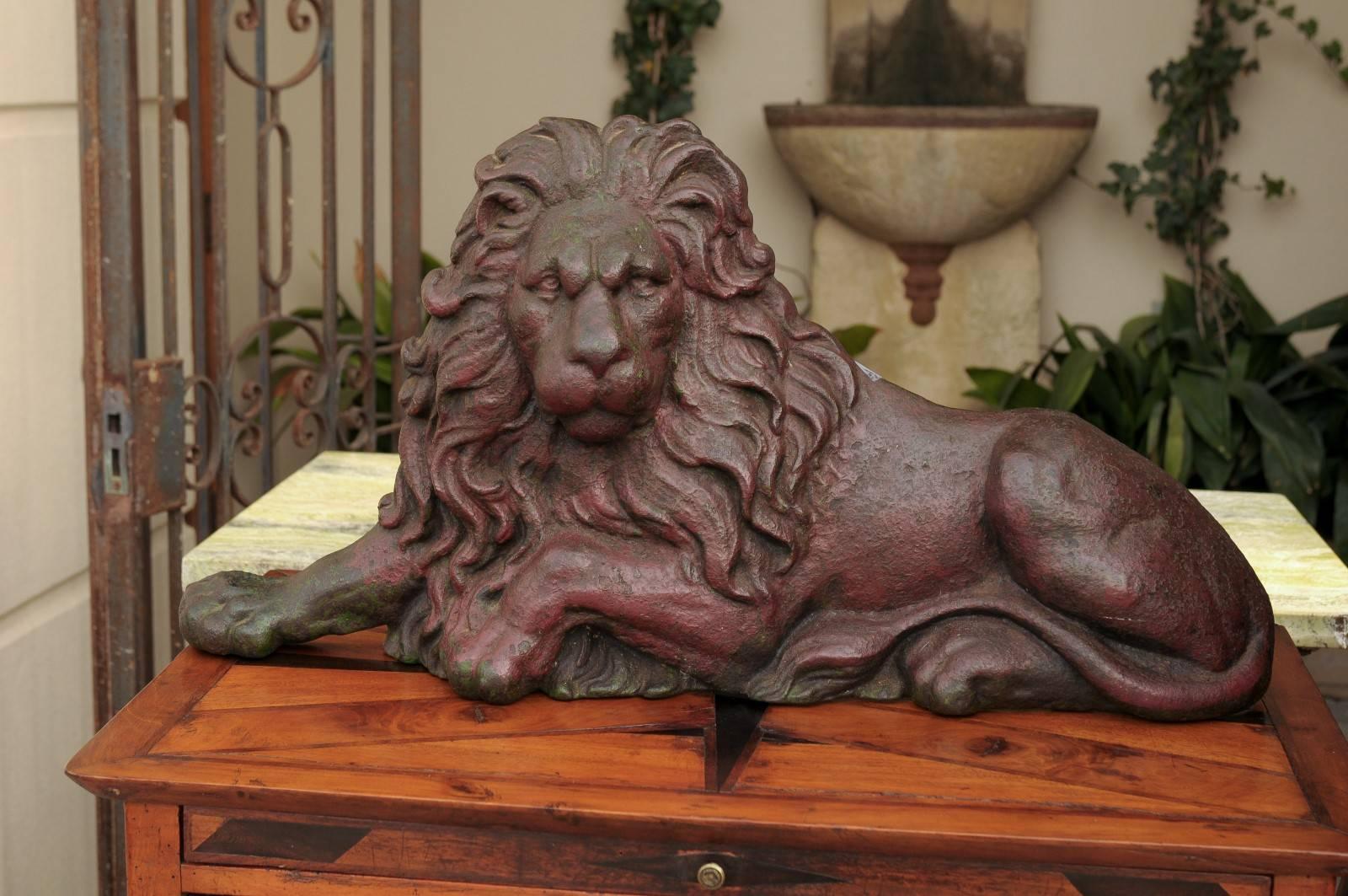 A cast iron lion doorstop from Victorian England. This 19th century Victorian cast-iron flat-back reclining lion is an elegant doorstop, probably after the magnificent original bronze pair by Sir Edwin Landseer displayed in Trafalgar Square. The