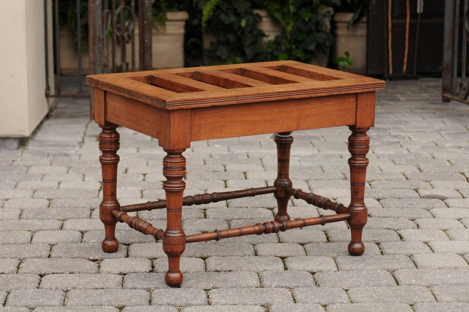 An English luggage rack made of mahogany. This English luggage rack from the late 19th century is made of a stunning rich mahogany. The rectangular top of this rack, circa 1880 shows the typical pierced shape. The clean lines of the top contrast