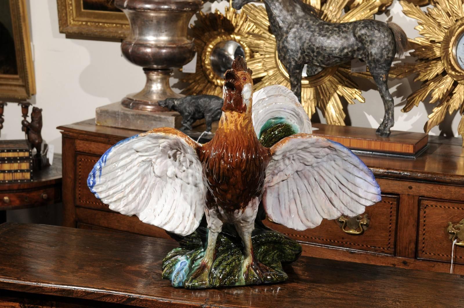 This early 20th century French Majolica features a rooster (the French national emblem) standing up, spreading its wings. This exquisite Majolica (tin-glazed earthenware) sculpture shows great craftsmanship in the treatment of the details. The