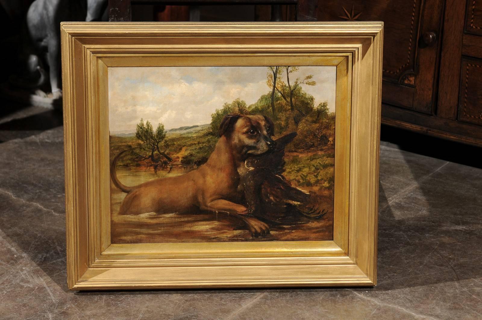 This pair of English oil paintings features two dogs placed in a country setting. The painting on the left depicts a water retrieving dog with a prey in his mouth. This hunting scene is focused on the dog whose tail exudes self-confidence for a job