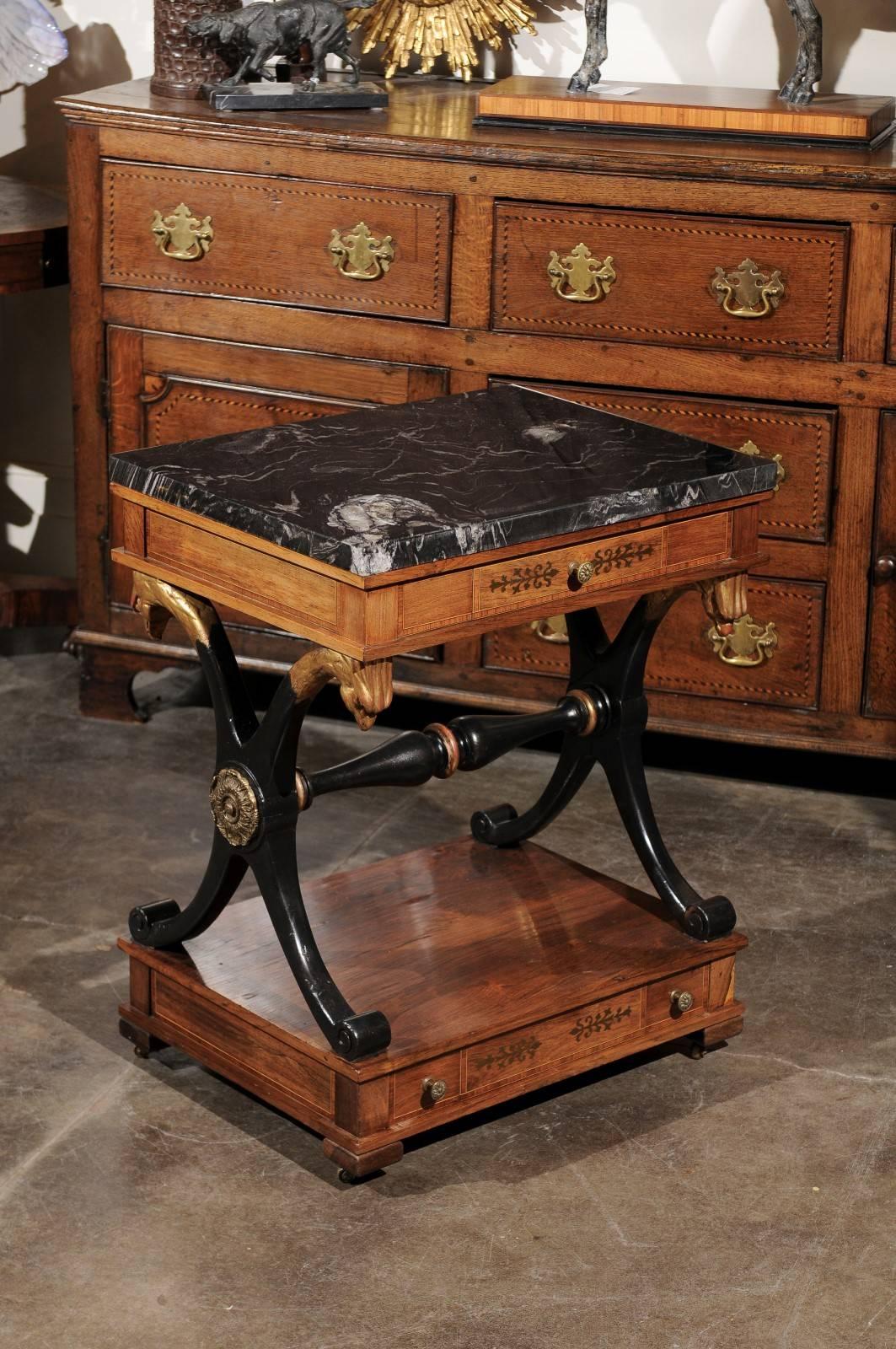 This English side table is an exquisite example of what Regency had to offer to England in the early 19th century. The two-toned rectangular stone top (black veined with white), is supported by an elegant apron with a single drawer in the front.