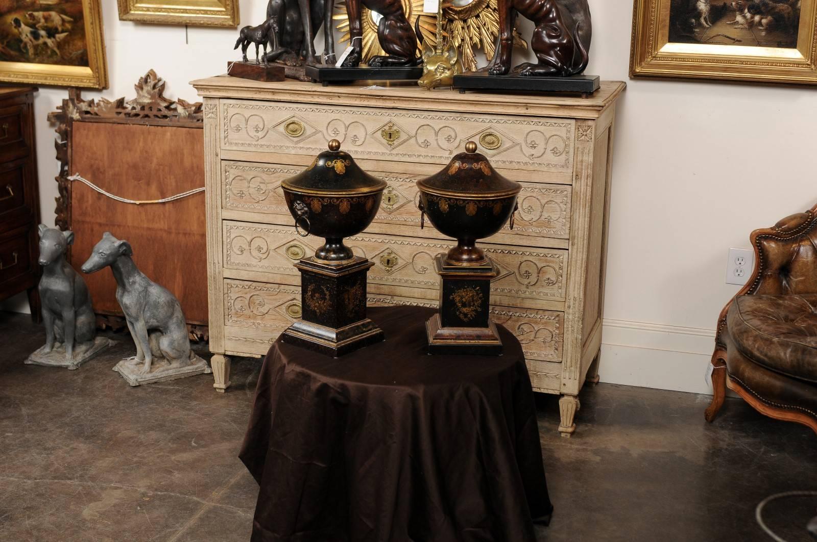 Pair of French 1920s Tole Black Tole Urns on Pedestals with Gilded Accents In Excellent Condition In Atlanta, GA