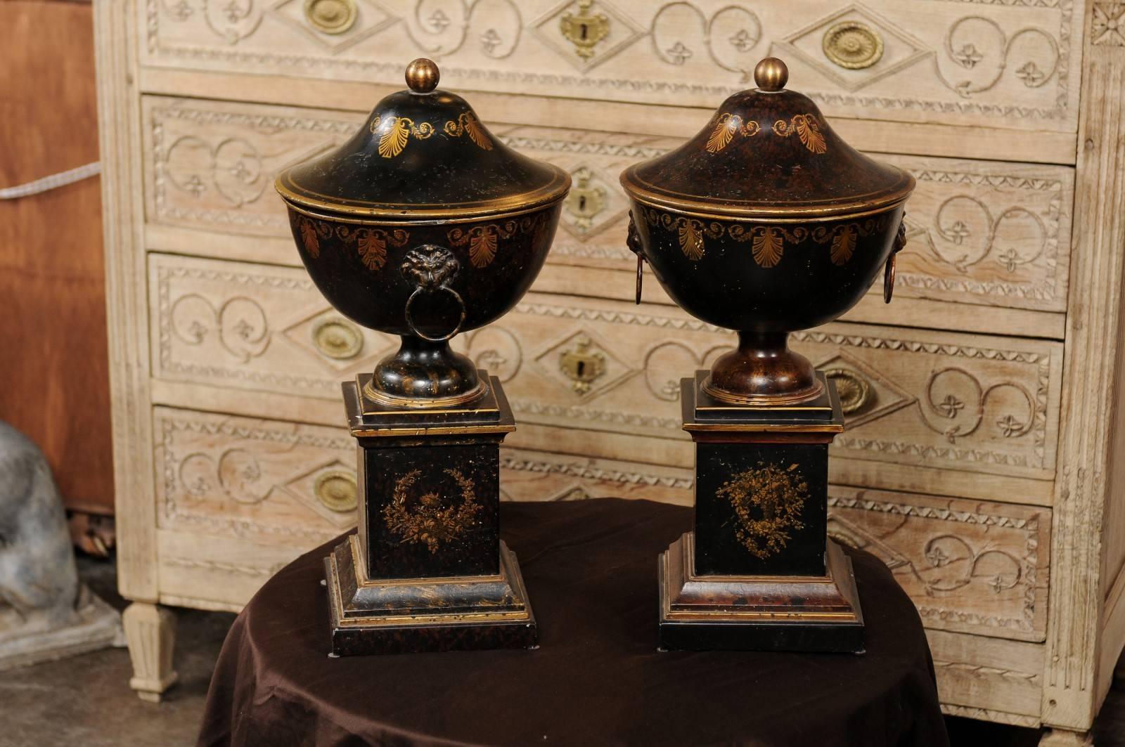 Tôle Pair of French 1920s Tole Black Tole Urns on Pedestals with Gilded Accents
