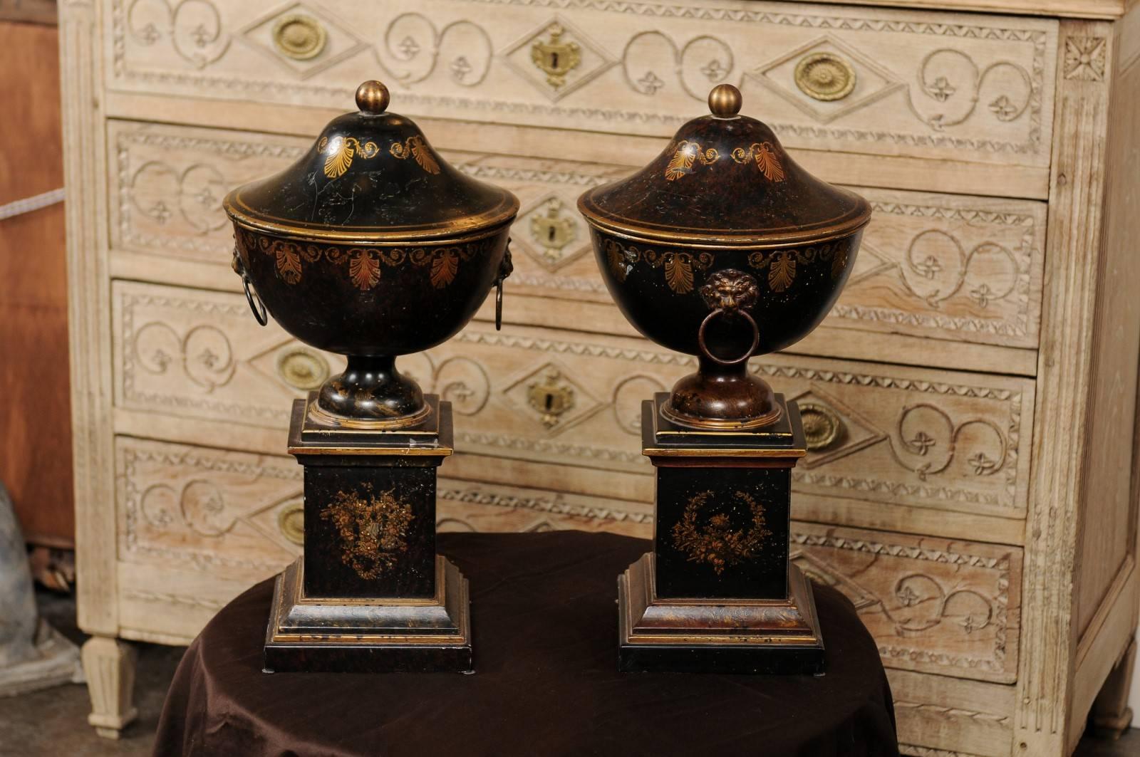 Pair of French 1920s Tole Black Tole Urns on Pedestals with Gilded Accents 1