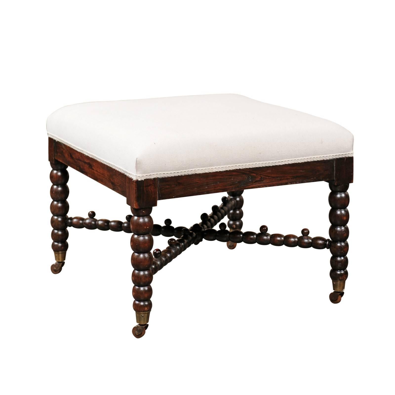 English Bobbin Leg Upholstered Ottoman with Unusual Cross Stretcher, circa 1880