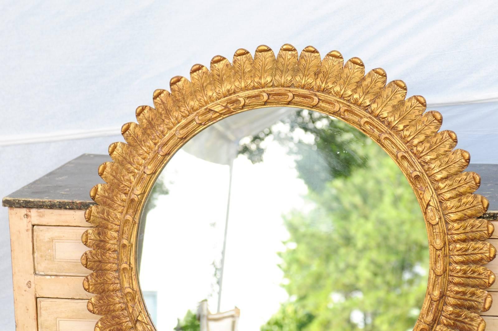 Carved French Round Giltwood Foliage Decorated Mirror from the Mid-20th Century